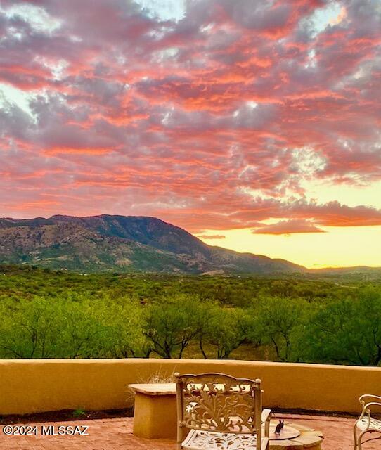 This distinct Southwest-inspired home offers breathtaking views of the Catalinas and is situated on 4 fully fenced acres of land. The custom home features rustic wood accents and offers a warm and inviting atmosphere. Stained concrete floors make for easy maintenance and add a touch of modern elegance. Expansive covered patios offer stunning panoramic mountain views and gorgeous sunsets. This home is a perfect blend of comfort and natural beauty, making it a truly special place to call home. Enjoy cooler temps with a property elevation of 4200'. Horse features include a lighted, wood-fenced riding arena, multiple stalls with pipe fencing and sun covers, a tack room, hay storage, and plenty of room to expand. This gorgeous home is 30 minutes from Oro Valley and only 45 minutes from Tucson.