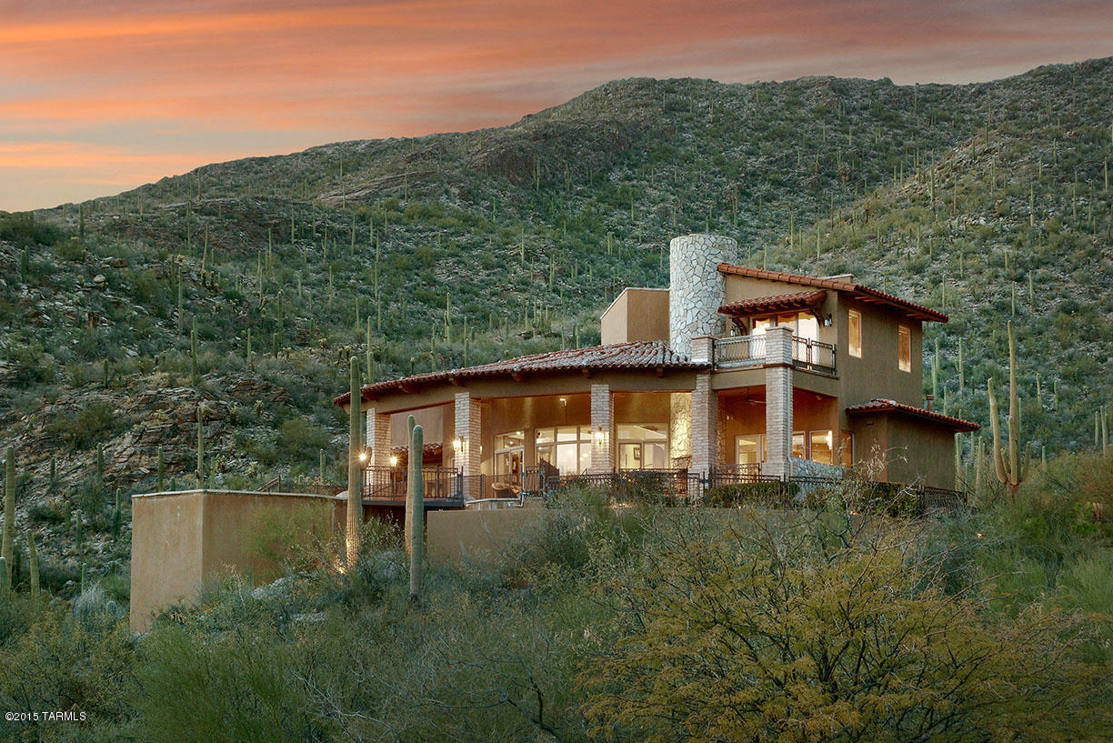 Fabulous custom home with beautiful finishes thru-out, sitting high above Ventana Canyon's famous 3rd hole of the mountain golf course. With vistas all the way to Mexico and the sparkling city lights, but only a few minutes from the clubhouse, easily accessible in the Mountain Estates. High end amenities include, Alder doors, beautiful Mesquite wood floors, stone fireplaces, gourmet kitchen with granite, stainless appliances, wine room which can become the elevator, custom wood built-ins in den and greenroom, lux master suite with a private deck to enjoy the views, huge closet and fireplace. Outdoors enjoy the deep patio with fireplace and BBQ, along with pool and spa.