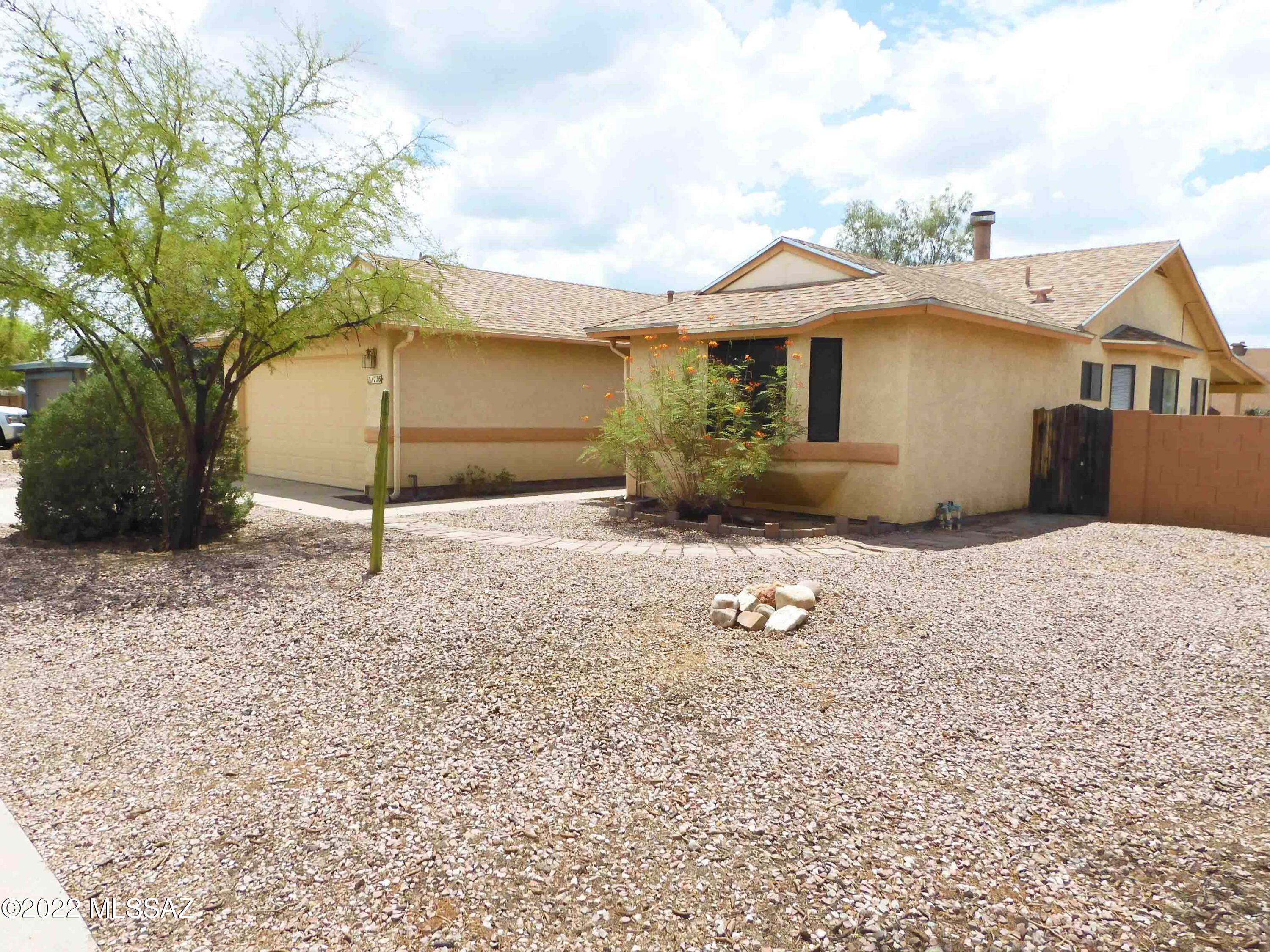 Freshly Painted 3 bedroom 2 bath home for rent in Marana school district! Large Corner lot. This home features a split bedroom plan, living room w/small fireplace. Kitchen has refrigerator, dishwasher, over range microwave & gas stove. Dining area off kitchen with bay window. Spacious Master bedroom. Master bath has dual vanities & soak tub/shower combo.  Laundry room w/ Washer/Dryer Hook-Ups. One guest bedroom is quite large. 2 car garage. Covered patio with extended paver block area & a fire-pit. Double gate access to yard. Community Pool & Sunset Pointe Park w/ ball field & playground. Close To Shopping W/ Quick Access To I-10. Nonsmoking house. 12 month minimum lease term. Animals require owner approval & additional deposit/fee. Proof of Renter's Insurance is required at lease signing
