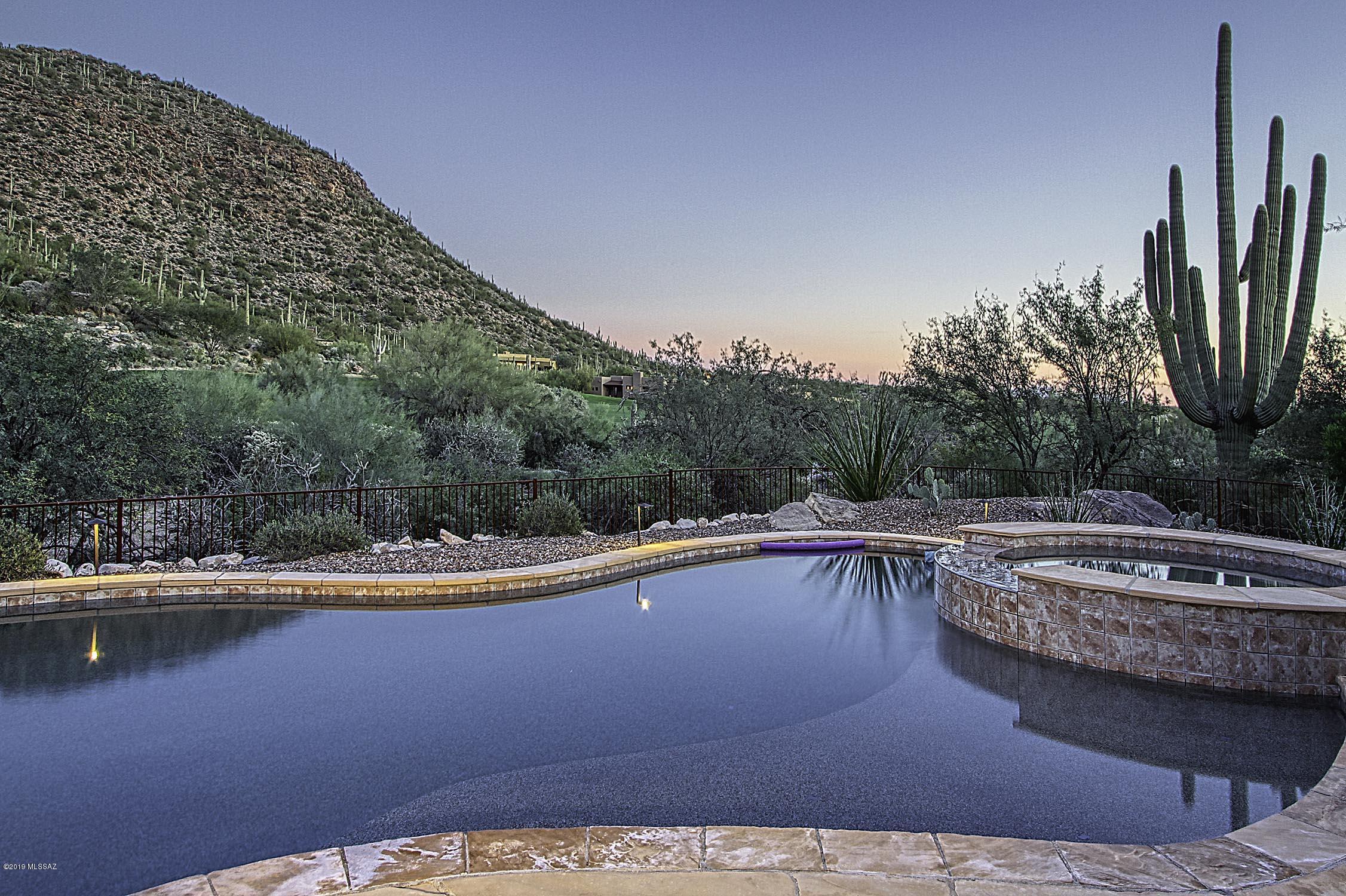 Luxurious Custom Contemporary in gated Solana at Dove Mountain is situated on the 16th hole of the Gallery North Course. Gated front courtyard opens to a casual yet elegant Great Room affording wall-to-wall windows offering dramatic panoramic views of the Tortolitas, golf course and sunset views. Amenities include 4 Bedrooms with en suites plus powder room, 4 fireplaces, Home Theater, 600+ bottle Wine Cellar, new porcelain tile flooring, Wolf/Sub-Zero/Miele appliances, 42'' cherry cabinets, and newer 1-touch saltwater system for Pool/Spa. Several private patios with views, outdoor Kiva fireplace w/seating, built-in BBQ. Deep shaded patios for outdoor dining and poolside lounging. Extended 3-car garage with storage room.