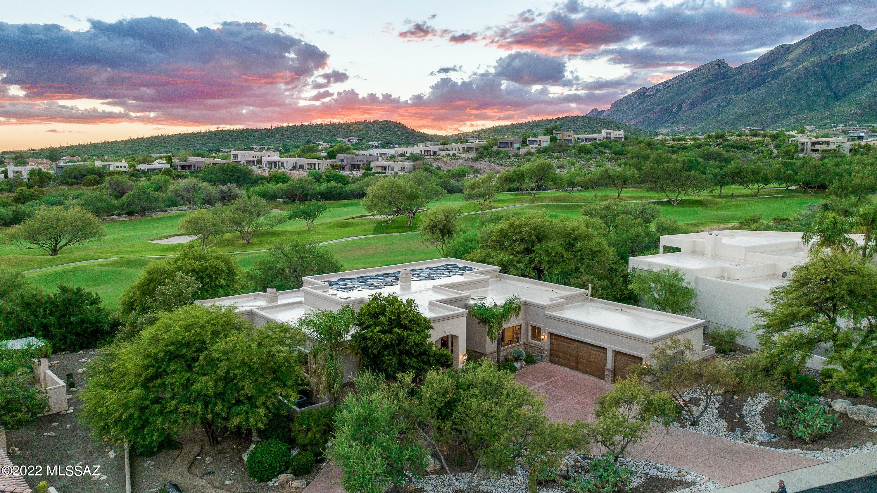 Live the Tucson Lifestyle in this meticulously maintained Southwest Contemporary Home.  Located on the 11th Fairway of the Ventana Canyon Golf Course.  This spacious split 4 BR/3 BA floor plan features beautiful  travertine floors, lighted niches, a cook's kitchen, a spacious master suite with dual sided see through fireplace and separate sitting area.  The oversized outdoor living area with large patio provides plentiful space for entertaining. Special features include flagstone patio, pool, spa and built in BBQ with enough seating for family and friends. Enjoy the picture perfect postcard mountain and golf course views.