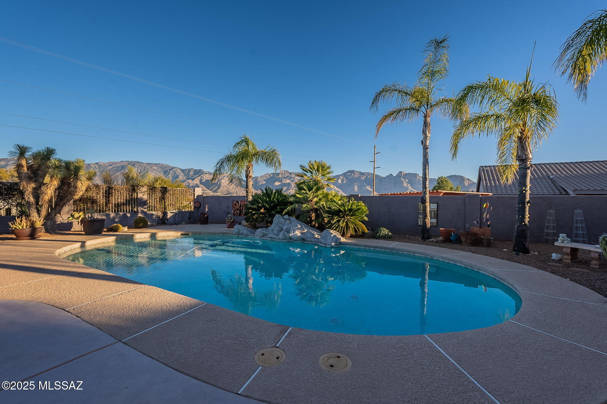 Looking for a scenic, private retreat?  The search stops here! Breathtaking mountain views await you at this inviting home nestled at the end of a quiet cul-de-sac. The private lot and courtyard offer a welcoming entrance to this beautifully remodeled home. The well-appointed kitchen boasts a large center island, updated cabinets, appliances and counters. Spa-like bathrooms have been tastefully updated.  Also features newer roof (2019), travertine and walnut wood flooring, custom closets and appealing security doors.  Awe-inspiring panoramic mountain views fill the backyard. Refreshing pool and soothing hot tub help create a private oasis. The generous covered patio, outdoor kitchen and private yard are perfect for relaxing, entertaining or enjoying al fresco dining.  Simply stunning!
