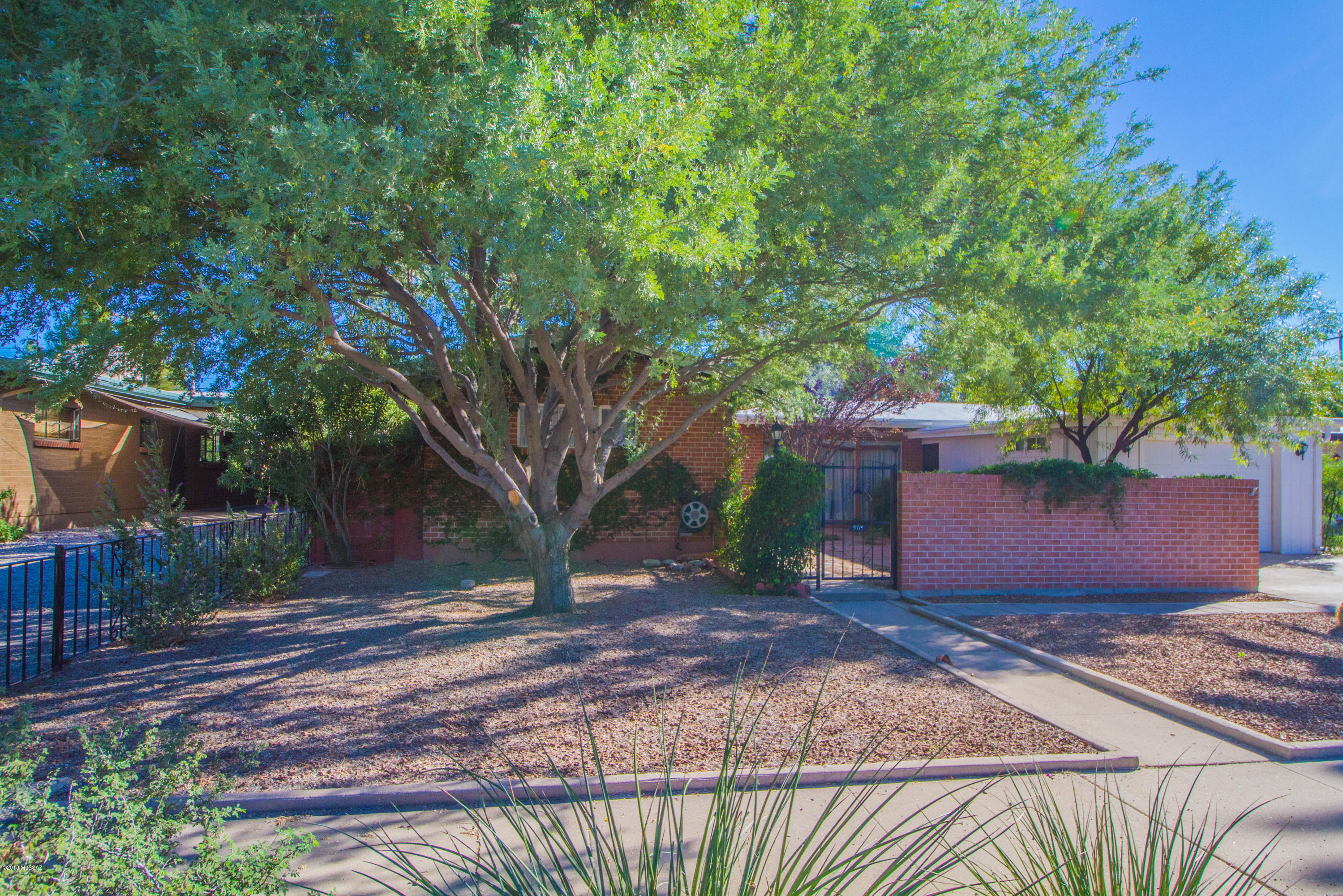 Move in Ready - Cozy Single Family 2 bedroom, 1 full bath adorable Brick house. This home offers its own personalized touches. Surrounded with Beautiful landscaping which will help keep this house shaded and Cool. It has the most relaxing backyard that provides you with your own Fruit Tree. Nice size Arizona Room with a unique Workshop. Must see this house in it's perfect location! Close to restaurants. THIS ONE WILL NOT LAST LONG!