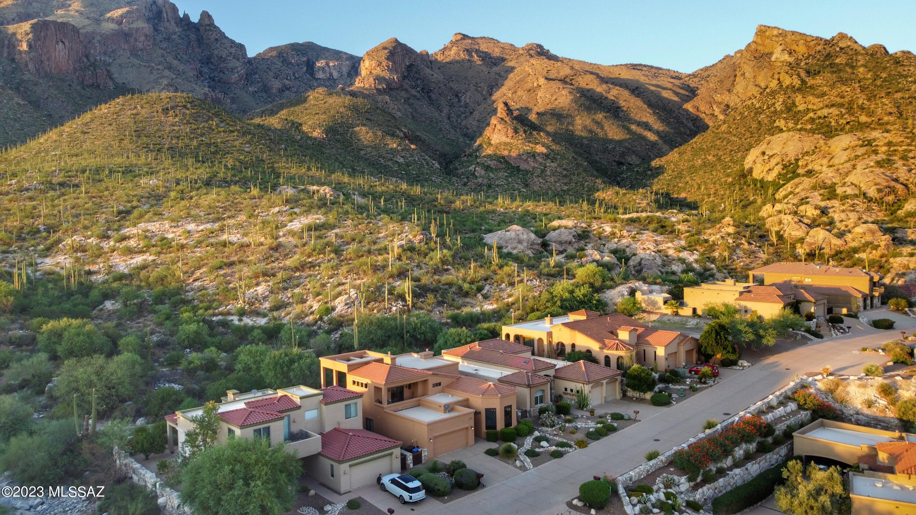 3961 E PLAYA DE CORONADO - A Rare Opportunity presents itself to own this stunning custom home built by Pathway Development in the highly desirable Gated Enclave, The Summit at Finger Rock, backing to the breathtaking Coronado National Forest with the Finger Rock trailhead right at your doorstep. If you're a nature lover, avid hiker, or just want to relax & enjoy the raw beauty of the magnificent Catalina Mountains literally right in your backyard, this home offers a variety of lifestyle options for you to choose and is the epitome of desert southwest luxury living. Located in what some say is the ''Best Kept Secret'' subdivision in Tucson, offering sophisticated, convenient urban living near modern amenities coupled w/the best views you will find hands down, this immaculate home is offered for the first time ever by the original owner/designer who built the home for casual indoor/outdoor living, entertaining friends and family, and to take full advantage of dramatic mountain and impressive city views through large walls of windows and private viewing decks. This soft desert contemporary home features designer finishes and touches throughout, soaring 20' ceilings in the great room with a gas fireplace, scored and polished concrete floors, a gourmet island kitchen with dining area overlooking the twinkling city lights, and expansive patios and balconies that allow one to immerse themselves in nature like no other home in Tucson. Inside you will find 3 spacious bedrooms, 2 full bathrooms, plus a powder room. The private second story primary suite offers two balconies - on the north side with private spa and captivating mountain views, and the south side designed for cocktails at sunset overlooking the city.  Once outside, a pebbletec pool w/waterfall surrounded by pristine artificial turf sets the stage for year-round outdoor living in your private oasis. A gas firepit is ideal for cool winter nights flanked by an outdoor shower for those hot summer days. The deep covered patio with gas grilling area makes al 'fresco dining and entertaining a luxurious experience your guests will never forget. This property transcends the ordinary and is sure to appeal to both part-time and/or full-time residents - adventure seekers and star gazers alike. The HOA maintains front yard landscaping, gate & trash. All furniture & most all the art/décor is available for purchase on a separate bill of sale creating a convenient, turnkey buying experience for the next stewards of this rare gem.
