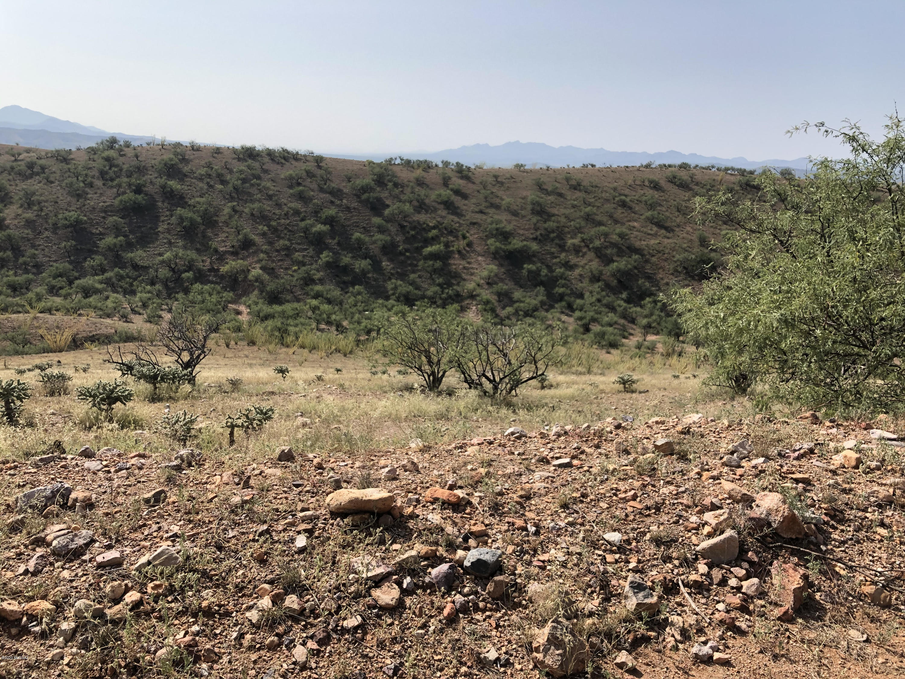Great 36 acre parcel of land at the end of Lado de Loma Dr.  Great views of the mountains, lights of Nogales and very private.  Backs to private ranch land.  This is a very great building site for a custom home.   Sunrise and sunset views every day plus watch the storms come in off the mountains.  Close to historic Patagonia and 20 minutes from Nogales,and 30 minutes from Sonoita wineries.   Patagonia, Az is marketing address. Mailing address is Nogales, Az