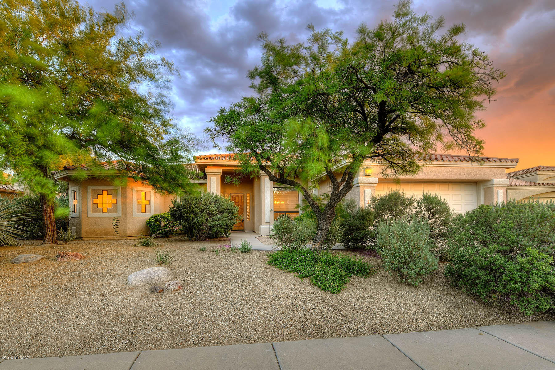 Outstanding 4 bedroom, 3 bath, 2,430 sq. ft. patio home located on a cul-de-sac in Oro Valley's gated and desirable Sunston Estates.  Through foyer into open, flowing floor plan with high ceilings and windows with lots of light, living room/dining room combination followed by kitchen/family room combination with fireplace.  New neutral interior paint, neutral ceramic tile, carpeting and wood laminate floors.  Kitchen offers granite counters and breakfast nook. Master suite features office/sitting room, his & her walk-in closets, dual vanities and spa tub.  Zoned heating and cooling, newer water heater 7/17, oversized garage with 16' of built-in cabinets, professionally landscaped front and year yards, wonderful oversized covered porches with brick paver floors,