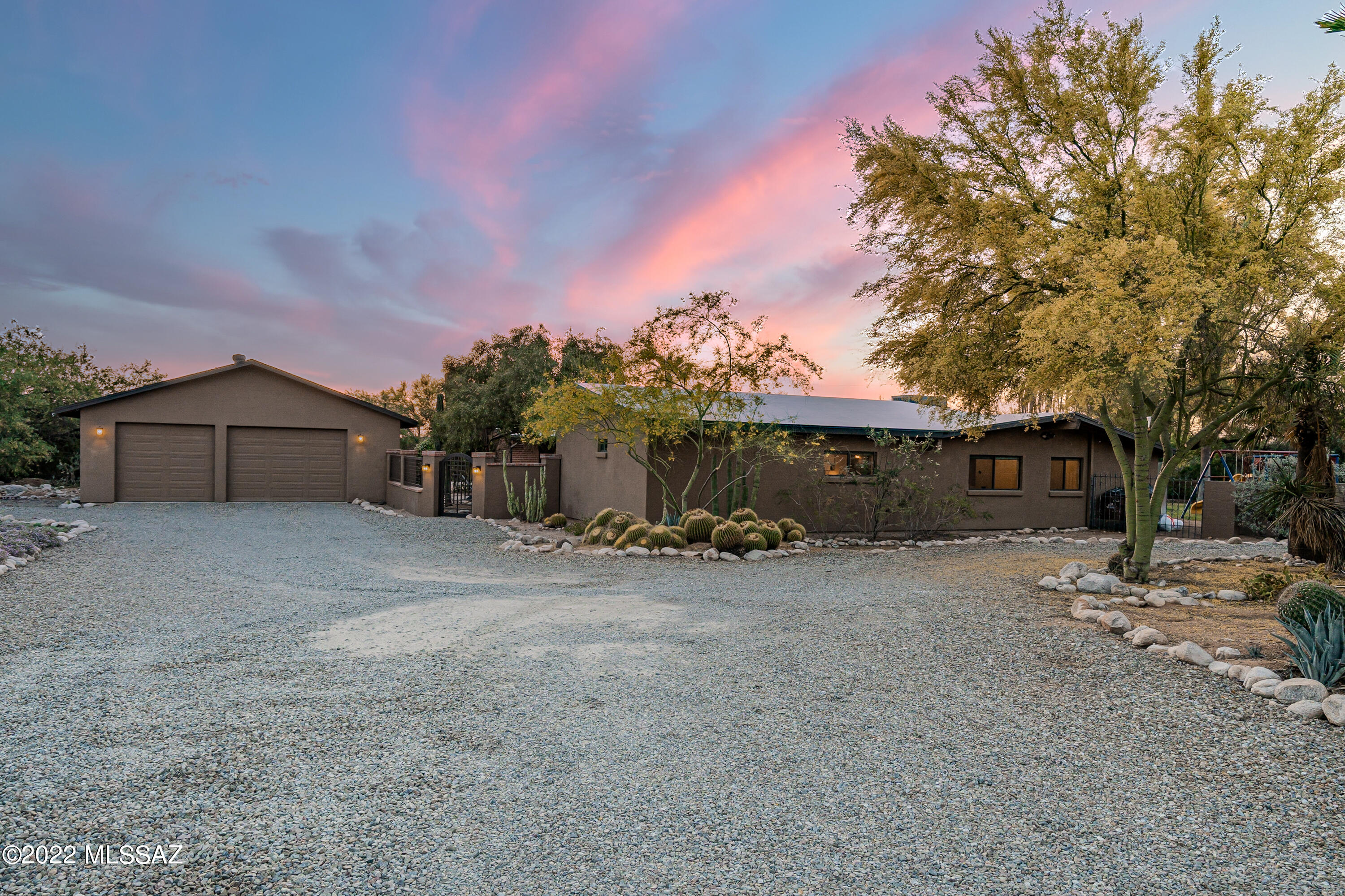 A little slice of paradise in NW Tucson. This beautifully updated 4-BD, 3.5-BA ranch-style home features dual master suites and is nestled among mature trees on a level 1.2-ac parcel with beautiful views of the Catalina Mtns. From the welcoming front courtyard w/ fire table to the huge walled backyard with sparkling pool, swing set, half-court bball, pirate fort, green house, chicken coop, hummingbird garden, huge date palms, and lots of privacy, the outdoor living in this home is perfect for families. The kitchen is smartly appointed with SS appliances, Wolf stove, Zephyr hood, and pro fridge & freezer. Dual zone AC with Nest thermostats. The huge garage has 9 ft ceilings and room for a workshop. Walk to Whole Foods, Casas Adobes Plaza. No HOA! This home has everything you're looking for!