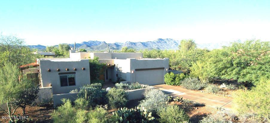 A private retreat with this Semi custom desirable Westside community home built by Sombra ,  tile and hardwood floors throughout, Upgraded kitchen cabinets, quartz countertops and stainless steel appliances, bathrooms with custom cabinets, granite countertops and dual sinks, New high efficiency windows , French doors, plantation shutters; landscape design by Jeffrey Trent large flagstone courtyard, brick extended patios .Step outside to enjoy the Catalina and Tucson Mtn. views & sparkling lap pool.