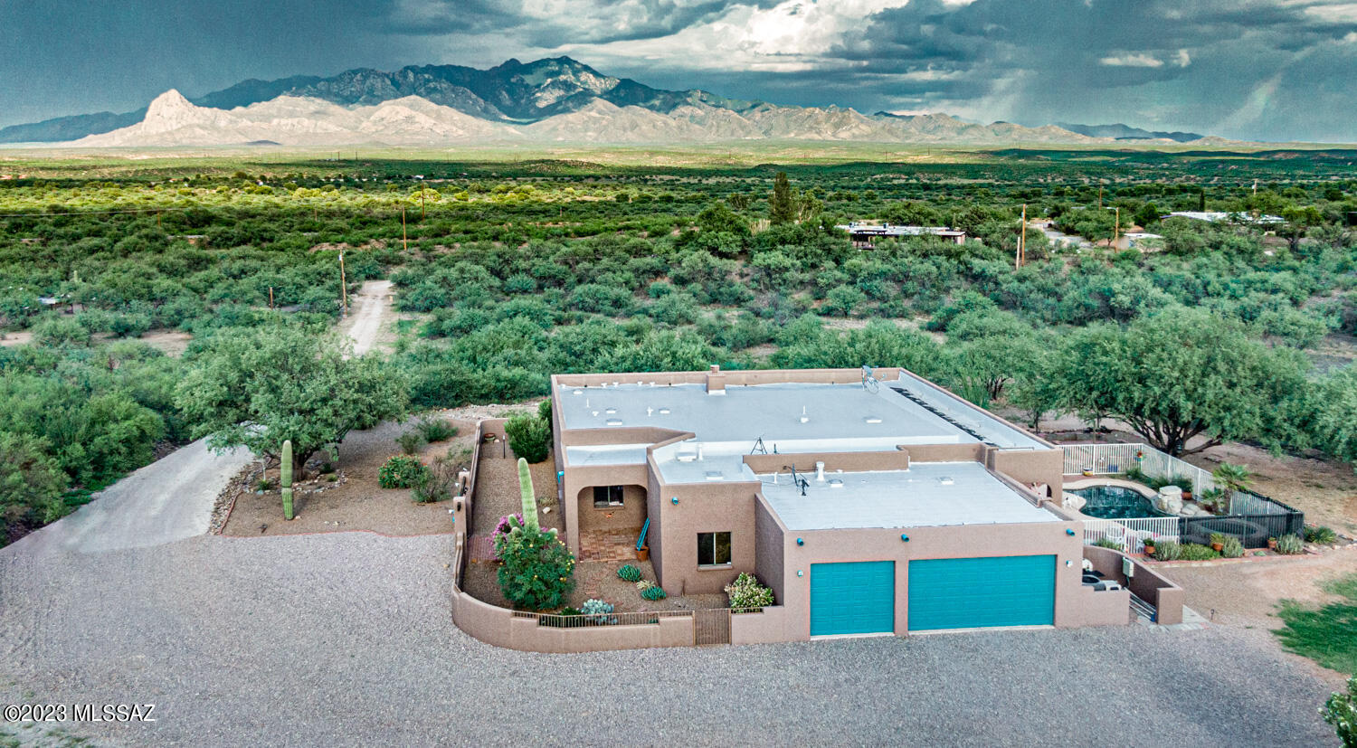 OWNER/AGENT. STUNNING VIEWS! Not only do you have a front row seat for the Santa Rita's take a gander out by the pool & watch first light of the day or spectacular sunsets on the Tumacacori's, too! Walk in the front gate to the beautiful courtyard with it's own saguaro; enter the front door to the delight of an open, easy flow, comfortable floor plan.  Entertain with ease with the many options for seating in and out!  Enjoy family BBQ's with the big fire pit with attached built in BBQ grill, splash in the pool when the temps are high, & enjoy the hot tub after a long day! You have horses or toys? No problem! Bring them!  There's a power outlet & water for an RV if needed!   The current owners have made thousands of dollars of upgrades at this wonderful home & property. More land available
