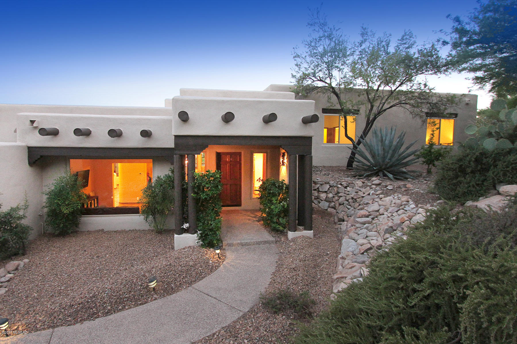 Enter this stunning John Kline Santa Fe home through wrought iron courtyard gate. Home is sited on cul-de-sac lot with unparalleled mountain and city views.  Featuring skylights, Saltillo tile flooring throughout and wood beamed ceilings. Master suite with beehive FP, hardwood floors, custom California Closet, sitting area and wall of windows with private entrance to patio.  Enjoy the resort like backyard with putting green, sparkling pool and spa.  Formal living room has been transformed into dramatic dining room with unobstructed views of the city.  Gourmet kitchen with SS appliances, wine refridge, generous eating area overlooks family room with masonry FP. Convenient proximity to Dist. 16 Schools, restaurants, shopping & golf. One of few homes with private gate in Alta Vista Estates!
