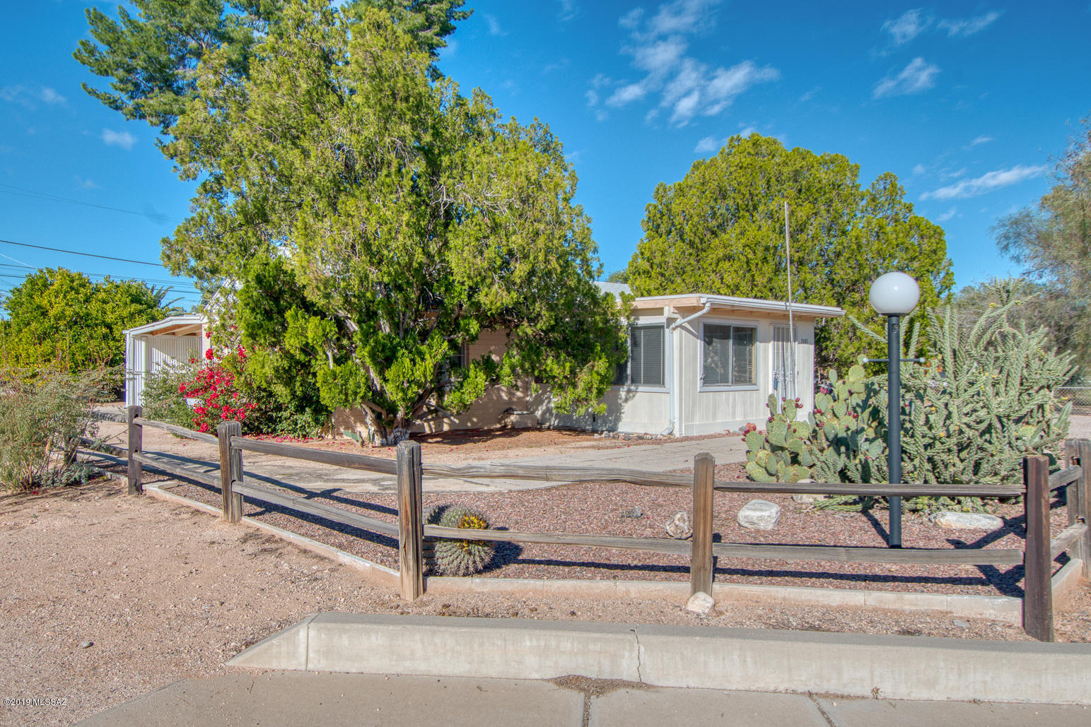 This 3 bedroom and 2 full bathroom home is in the perfect central location. 1.5 Miles to Tucson Medical Center and just 4 miles to the University of Arizona Campus. Fresh paint, tile and carpet. Great bonus room off the kitchen could be a den/ office or additional hang out space. Possible automatic Income potential with the long term guest house tenant.