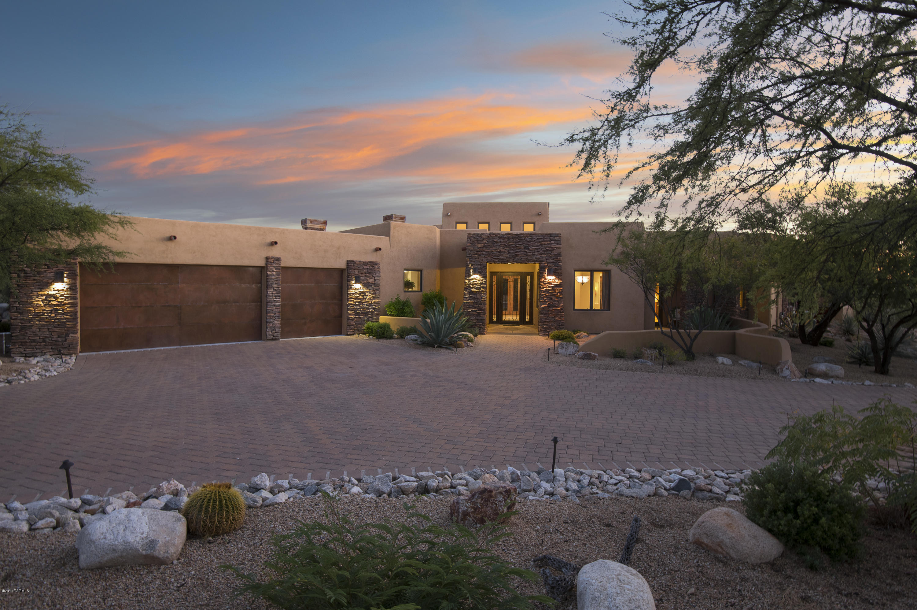 Located in the prestigious guard/gated community Stone Canyon Club on extremely private setting with many amenities.
An inviting brick paved driveway that leads to this peaceful one acre lot with numerous walkways, sitting areas and fountain with stunning mature landscaping everywhere you turn.

When entering this home you will see through to this glorious back yard. A private paradise with vine covered  patio, lush mature landscaping outdoor fireplace, Spa with water feature and built in BBQ grill. Outdoor living at its best including a gracious stairway to spacious roof deck with spectacular views of the Santa Catalinas, Tucson, and Tortolita Mountain ranges.  In addition, amazing panoramic views of the Tucson city lights! Perfect for entertaining or just relaxing.