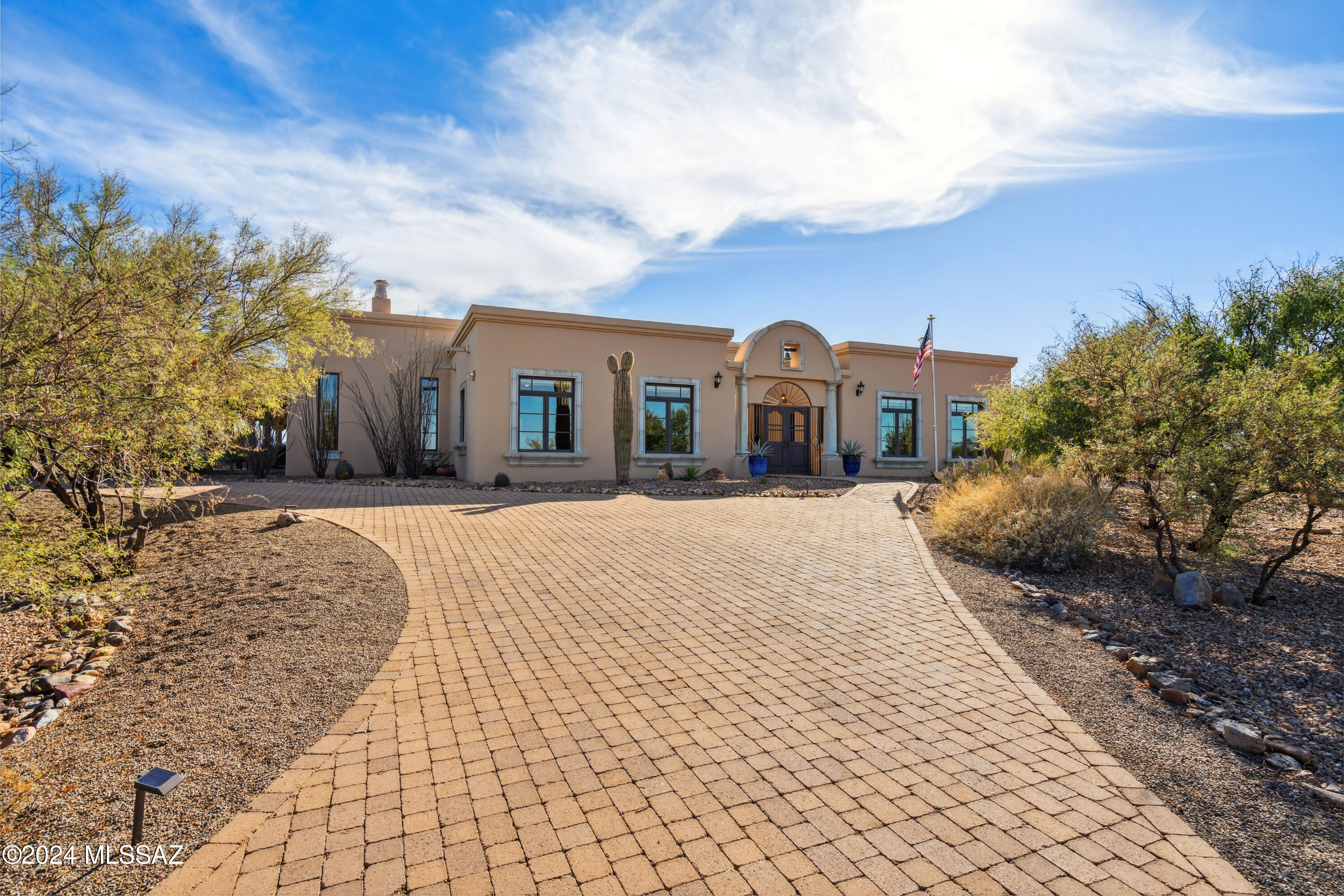 If you enjoy entertaining on a grand scale or just hosting family and friends in a more intimate setting, then HACIENDA VENADO is the home for you.  This 5,867 sf Hacienda Style home is located on 2.9 acres in the Madera Foothills Estates subdivision with Magnificent Mountain and Desert Views from every room. The home is artfully arranged around a Central Courtyard with lush greenery, a Fountain, a Fireplace and an Outdoor Kitchen equipped with a 5-burner Natural Gas Grille, Refrigerator and Sink. The Courtyard opens onto the beautifully designed and recently installed Omni Pool Builder's Heated Pool and Raised Spa which is surrounded by Travertine decking and native landscaping, making it a true Sonoran Desert resort. Integra Block Construction, with walls that are 16'' thick, provides superior insulation as well as architectural authenticity. Additional architectural features include a Massive Great Room with Wood Beam Ceiling and High Gunsight Windows, Oversized Pella Windows and Exterior French Doors, Custom Draperies and Cornices, Alder Wood Cabinets and 8' Interior Doors, 18" Tumbled Gray Quarry Tile Flooring, 3 Interior Fireplaces w/Stone Surrounds, Archways and Elegant Columns that mimic the exterior style. The kitchen features a Viking 4-Burner Gas Cooktop w/Grille and Griddle Pans, Viking Warming Oven, new GE Cafe' appliances, 2 Under Counter Refrigerator Drawers, beautiful Soapstone Countertops, Alder Wood Cabinets, Prep Sink and Pantry. The Enormous Primary Bedroom Suite has its own Patio, Fireplace, His & Hers Primary Closets w/an adjoining Office, Hobby Room & Laundry Room. The 5-pc Primary Bath has 2 Copper Sinks, a Jacuzzi Tub & Walk-In Tile Shower w/3 shower heads. Keeping with the Hacienda Style, the 3 BR/1 BA attached Casita is decorated w/rich colors & Mexican Tiles. It has its own separate heating and cooling system so when not in use it can be turned off for more energy savings. The 3-Car Garage w/Oversized Door can accommodate a Class C RV. The garage floor is epoxied for easy cleanup and 2 storage rooms provide plenty of space for tools & equipment. The pool was installed with Pentair equipment. This is an extraordinary home and one that must be seen to appreciate. Furnishings available on SBOS. A list of inclusions & exclusions is available for review.  Four new Rheem 2-stage HVAC split systems scheduled for installation (Feb 2025).