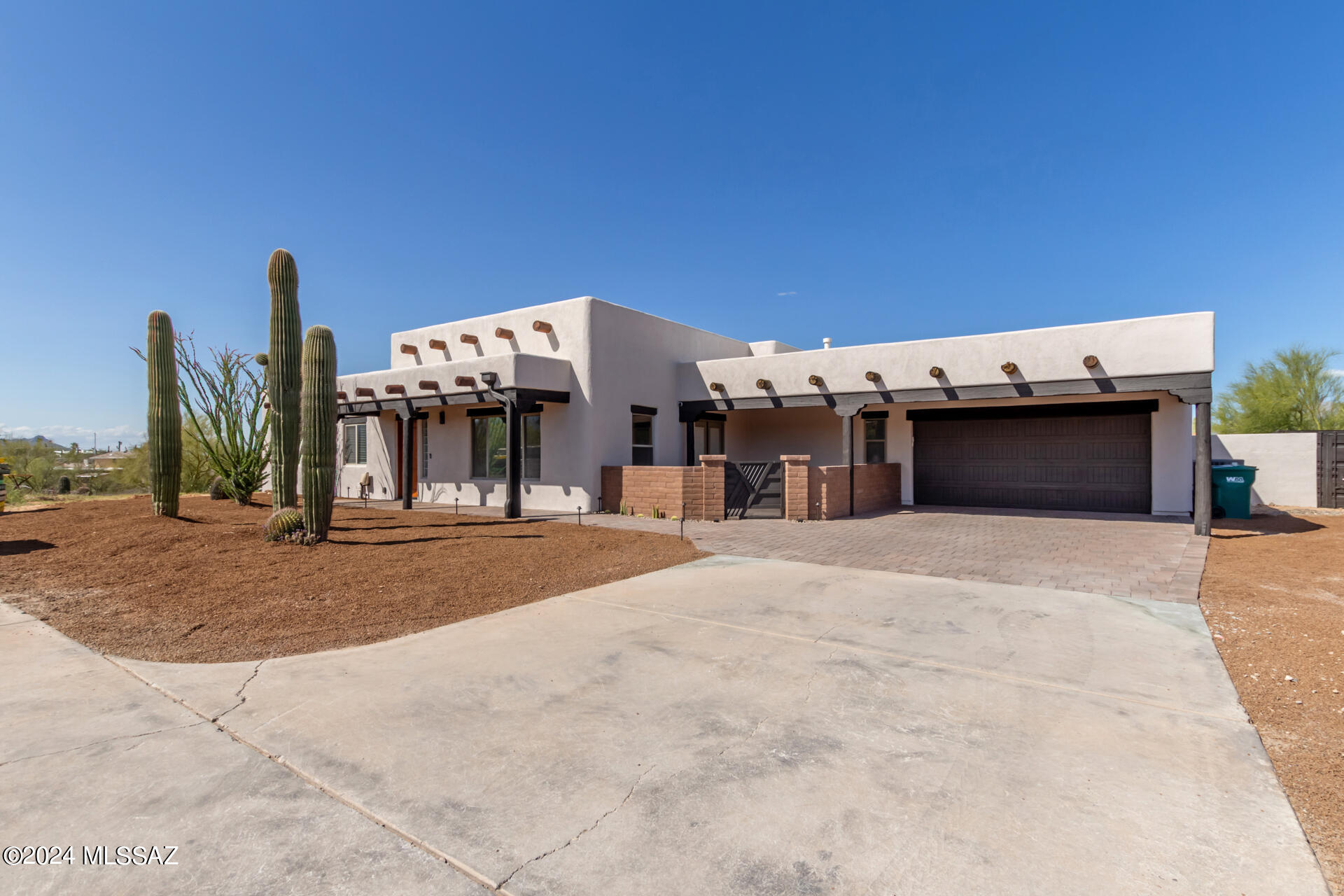 Become the proud owner of this captivating 3-bedroom home on a 1-acre cul-de-sac lot! The property greets you with a 2-car garage, stylish pavers, a low-maintenance desert landscape, and a welcoming patio. The living room boasts high ceilings, a cool palette, track lighting, and attractive wood-look flooring. The great room features a stone-clad fireplace with an insert and chic light fixtures. The kitchen comes with granite counters, ample white cabinetry, a subway tile backsplash, Grey SS appliances, and an island with a breakfast bar. You'll also find a versatile den for work or leisure. The main bedroom offers direct backyard access, a walk-in closet, and an ensuite with dual sinks. Enjoy breathtaking mountain views from the roof deck. The enchanting backyard includes a covered patio, built-in BBQ, a charming gazebo, warm firepit, a spa, and a sparkling pool. See this gem today!