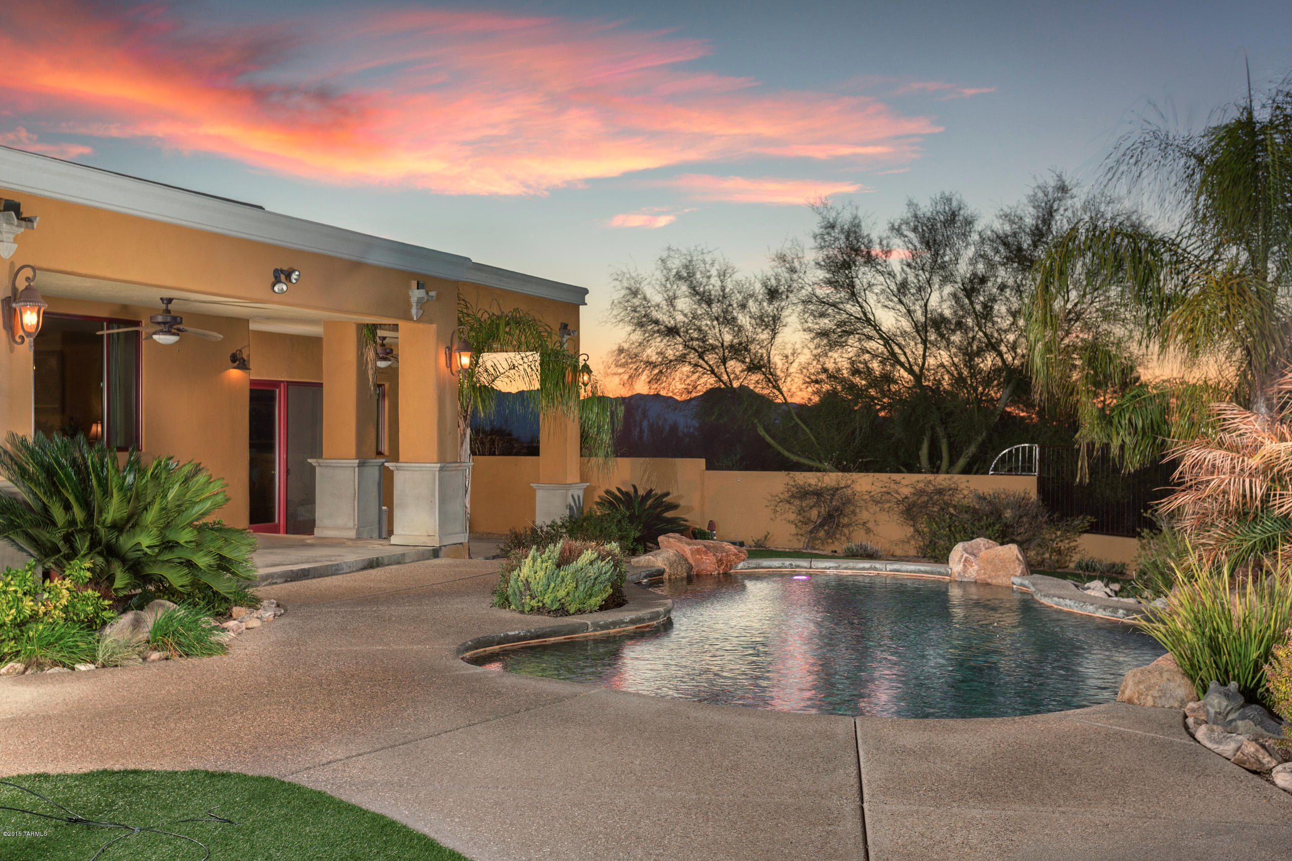 Seller will accept or counter offers between $799,900-$849,900. Spectacular home in desirable Catalina Foothills Estates! This oasis in the desert has soaring ceilings, water fountain, courtyard entry, staggered travertine flooring, custom tile work in kitchen & bathrooms & wood beamed tray ceiling! Gourmet kitchen with granite counter tops,built-in wine refrigerator, custom vent hood,slate back splash and stainless steel appliances. The master suite will be your private retreat with a large bedroom & spa-like bath complete with separate shower & jetted tub, custom tile work, his & her vanities and closets with organization system. Enjoy your backyard oasis with the sparkling pool with tranquil water fall, fireplace, viewing deck and stunning Catalina Mountain and sunset views!!