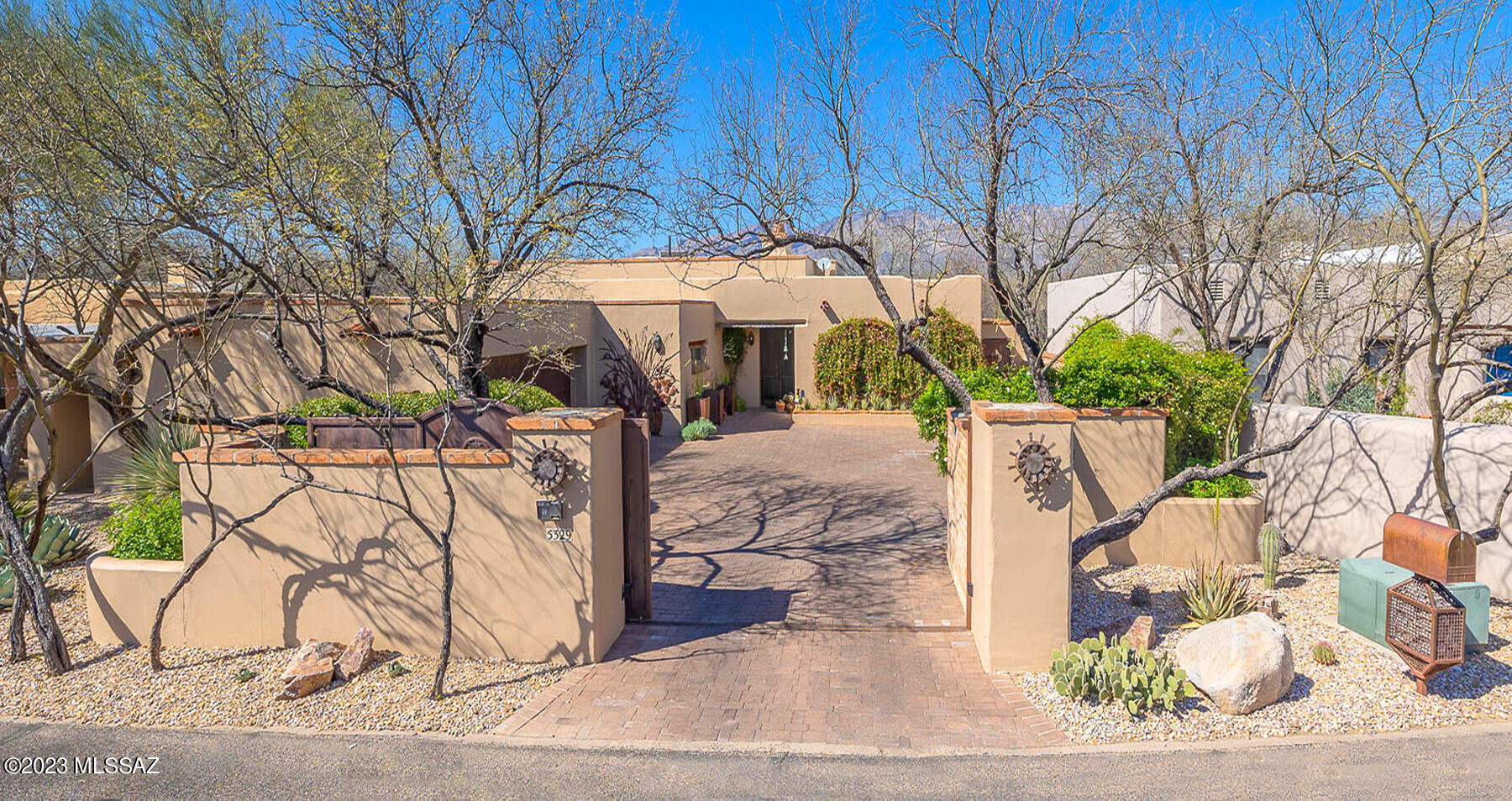 Situated in a picturesque mesquite bosque in the Fort Lowell Historical District, this architecturally unique home w/3BR/2.5BA + den was designed to imitate a Sonoran territorial. The built-in BBQ, multiple patios, one of a kind pergola & exquisite professionally redesigned gardens by Artistic Landscape Architects, are perfect for enjoying Tucson's outdoor lifestyle. French doors, adobe walls, vigas, barnyard & hand carved doors & hand painted Mexican clay tiles maintain the historical authenticity. The kitchen has been meticulously remodeled with all the modern conveniences including corian counters, upgraded appliances & gorgeous alder wood custom cabinetry. The 12 ft. hi ceilings, custom lighting & scored concrete floors accentuate the open floor plan.
The primary BR has 2 walk-in closets. built-in bookshelves & an ensuite bathroom w/a large shower & bear claw tub.  The den is a perfect quiet get-a-way for relaxing with a book or watching TV. It has a closet & could be used as a 4th BR.
The walled-in gated entrance to the property provides security as well as privacy. 
Zoned AC and Evaporative Cooling. Conveniently located to shopping and restaurants.
The beauty of this property is in the details.
