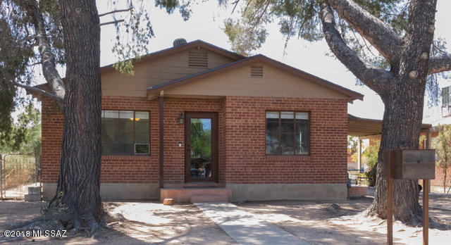 A stone's throw from both Banner and the U of A this home has a location and features that are unmatched.  Start with the main house, a brick bungalow style three bedroom one bath home with beautiful concrete flooring throughout.  The kitchen features knotty pine cabinetry for plenty of storage and a great amount of granite counter space.  The dining area connects to the spacious living room with recessed lighting throughout for a bright and clean feel.  Newer HVAC and roof work make this an unbeatable deal.  The Guest house is a southwest style two bedroom, one bathroom gem with a great room concept. The huge kitchen has more than enough storage and tiled living room is open and airy with high ceilings. Add in a laundry room and AZ room with private alley parking and access, separate utilities (aside from water), newer HVAC, and you've got an investment or rental opportunity that will move fast.  Come see it before it's gone.