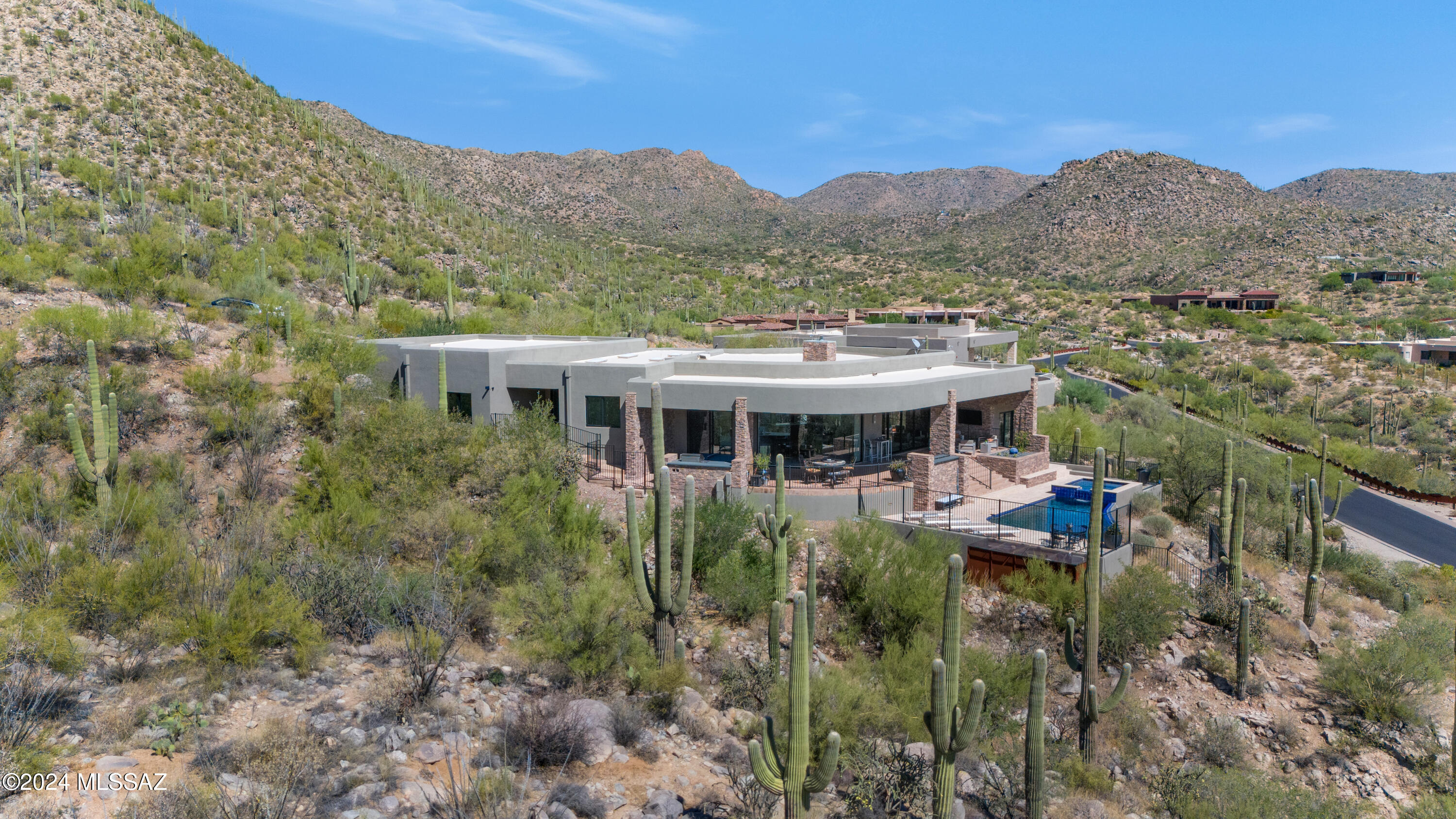 Resting on a private lane in the prestigious Canyon Pass neighborhood, this contemporary masterpiece awaits the most discerning buyer. 

The modern gourmet kitchen features Neff Cabinets, Sub-Zero Pro Refrigerator, Wolf dual 48 with French Stove top, Miele coffee maker, Zephyr Bobby Cheng hood with rooftop blower and Ceasar stone countertops.

The glass encased great room showcases custom Gascogne limestone flooring and majestic 180 degree mountain and canyon views.

A 20 foot sliding glass door leads you to a gigantic wrap around patio with multiple sitting areas that are perfect for lounging by the fire while taking in the jaw dropping views.

This really is a trophy property offering an unparalleled piece of Desert Paradise.
