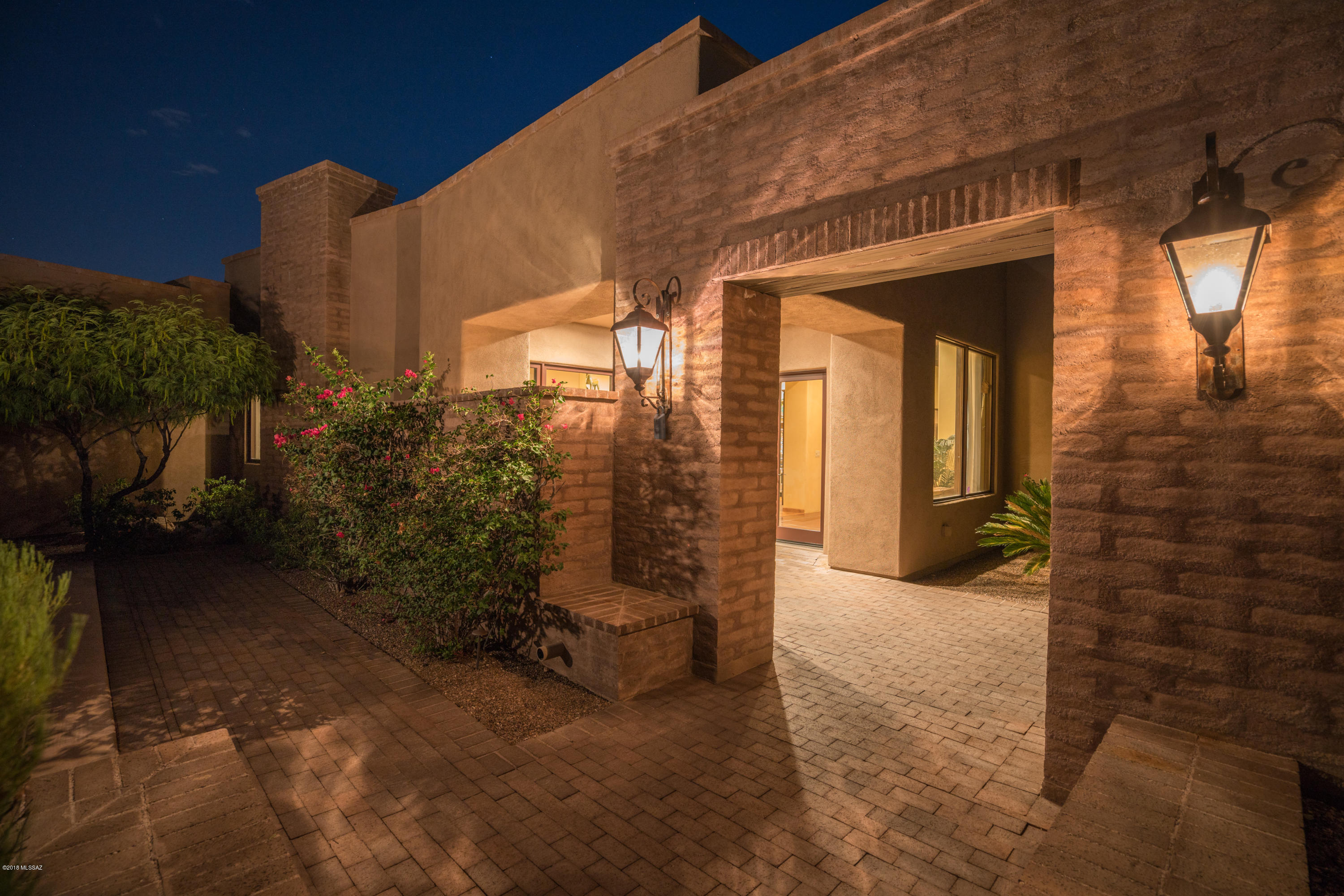 Breathtakingly beautiful home with attention to details; thoughtfully situated on an acre of land with BOTH city and mountain views. Enter this exquisite property via a welcoming foyer, Vega beamed ceilings, gorgeous concrete floors, and grand windows that frame the amazing mountain vistas. Well-appointed kitchen features concrete counters, beautiful cabinetry, Wolf stove and oven and an impressive island overlooking the spacious family room. Ideal split floorplan features spacious bedrooms with private bathrooms and walk-in closets, while the master suite offers privacy and patio access to the backyard.  Private yard with multiple covered patios, built in BBQ, and an impressive fireplace. All of this plus a sparkling pool & spa overlooking stunning panoramic city views.