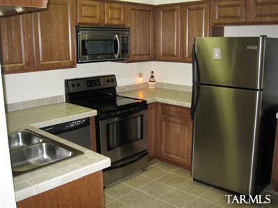 2 Bedroom 1 Bath Condo. Gated condo community in the heart of Tucson. This ground floor unit is next to one of the pools and the sand volleyball court. There is also a tennis court, rec. center and laundry facility.