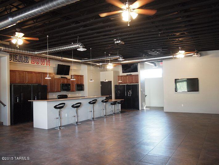 Unique Student rental opportunity within 4 blocks of the University of Arizona. Completely remodeled building (2012) that includes 5 HD TV`s in modern warehouse style layout with backyard patio! 17 Bedrooms, 9 bathrooms, built in booths, huge breakfast bar area, large covered porch and walled in back yard. LEASED THROUGH JULY 2016! House was designed to accommodate large group of students wanting to live together. All tile, Zoned AC, corian counters in kitchen, cultured marbled wayne's coated bathrooms. Actual numbers from 2014. Management can be retained. Packet available upon request. One of the Selling Members of the LLC is licensed to sale real estate in Arizona.