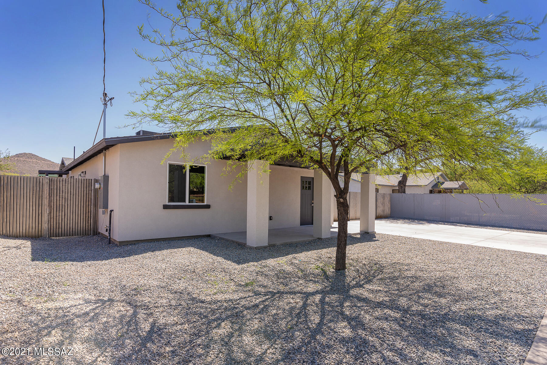 Menlo Park Historic Neighborhood.  This property has had a full remodel of the existing part the of home and a new 1,060 sf addition was added with permits in 2020/21, for a total of 1,765 sf on an R-2 lot. Great location being in such close proximity to Downtown Tucson/I-10 and the charming characteristics of the vintage Menlo Park community.  A short walk to the trailhead for Tumamoc Hill as well.  The home has four bedrooms and two bathrooms and everything inside and outside of this house is New including the AC and sewer line and connection. The remodel includes New kitchen, baths, flooring, roof, dry bit stucco, interior and exterior paint, doors, locks, windows and the list goes on and on - the majority of the home is new construction after all.  There is a laundry room and a small porch on West and East side of home and a nice front porch on North side covering the font door.  The wide concrete driveway is new and can easily hold two cars.  The yard is good sized and fully enclosed with a new and rustic corrugated metal fence.  This home will not last long so come and see today and submit your offer!