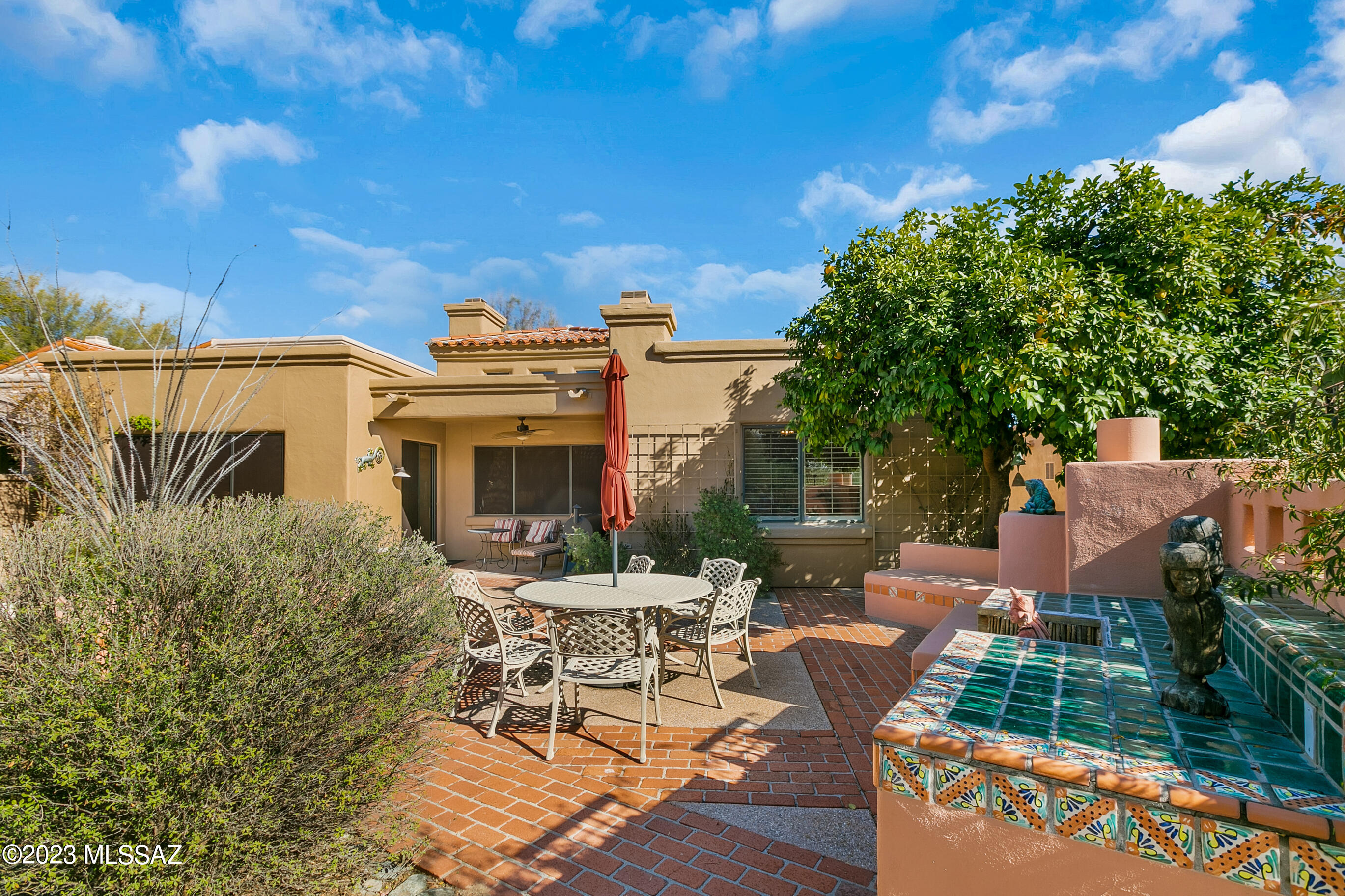 Wonderful gated La Paloma AF Sterling home backing to beautiful, private open space. High vaulted ceilings, open kitchen with newer double ovens, beautiful granite counter tops and raised panel cabinetry. Saltillo tile throughout with newer carpet in the bedrooms. Vibrant colors. Large professionally landscaped rear yard with built in grill, fireplace and mountain views. Separate living, dining and family rooms. Dining room currently used as an office/library. Large primary suite with fireplace. Newer roof, air conditioning condensers, water heater. Owned solar. Laundry room with cabinets and sink.