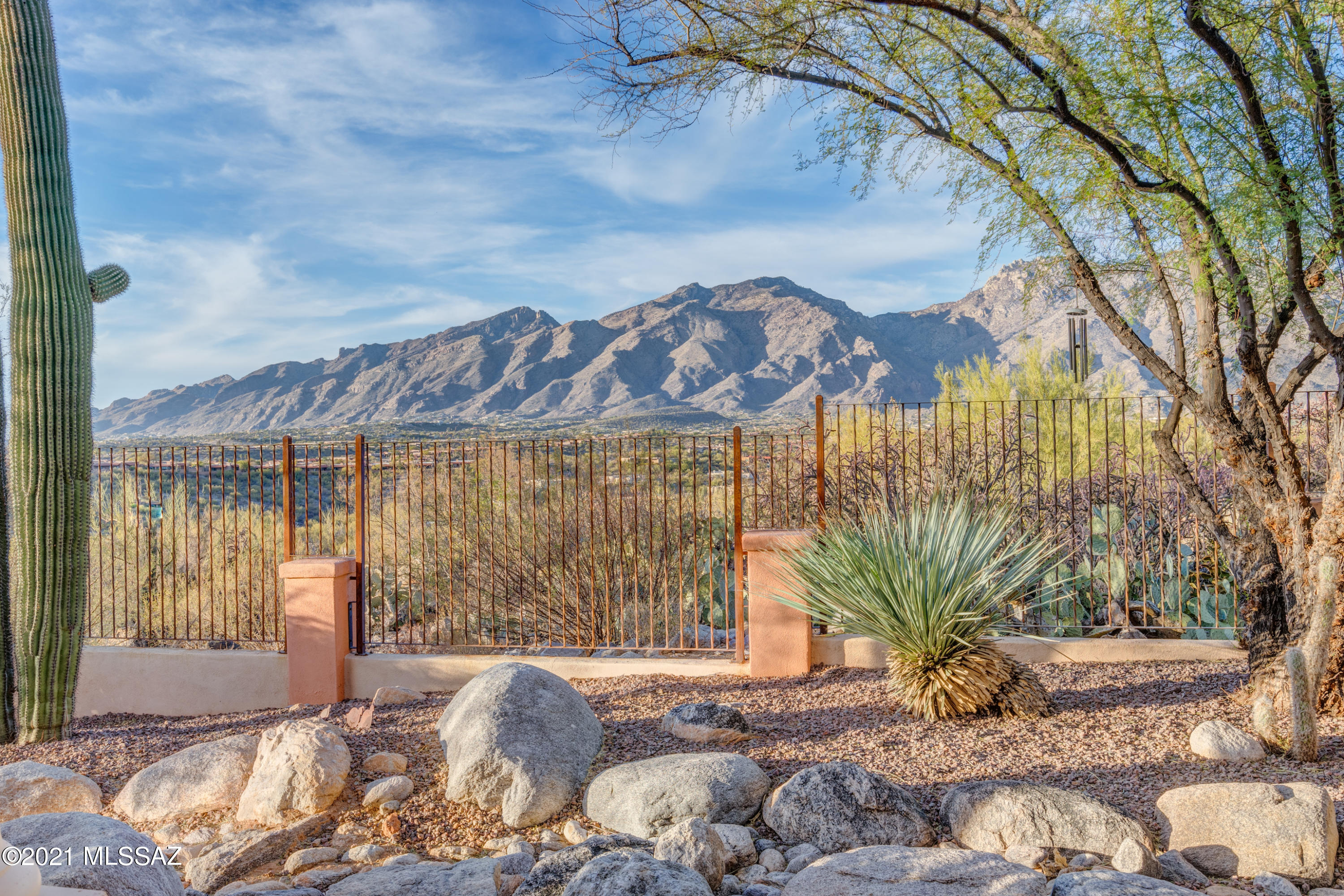 Views Views Views of the City and Mountains. This is the BEST lot in Canyon Ridge! Old world charm, move-in ready... you won't want to change a thing.  Herringboned hand laid brick and wood floors throughout!! Mesquite wood  doors & kitchen cabinets, Concrete counters in the gourmet  kitchen, with a granite island.  Concrete counters and designer sinks in bathrooms.  Built in wet bar in great room with wine refrigerator. Split plan with extra large master bedroom, closet and bath!  Exposed aggregate driveway leading to three car garage w/ additional storage that enters into oversized laundry room.  Eighteen foot ceilings in Great Room. Unobstructed Mountain and City Views.  Call LA for more  details  (two small steps leading to the North wing).   Plenty of room in yard pool.