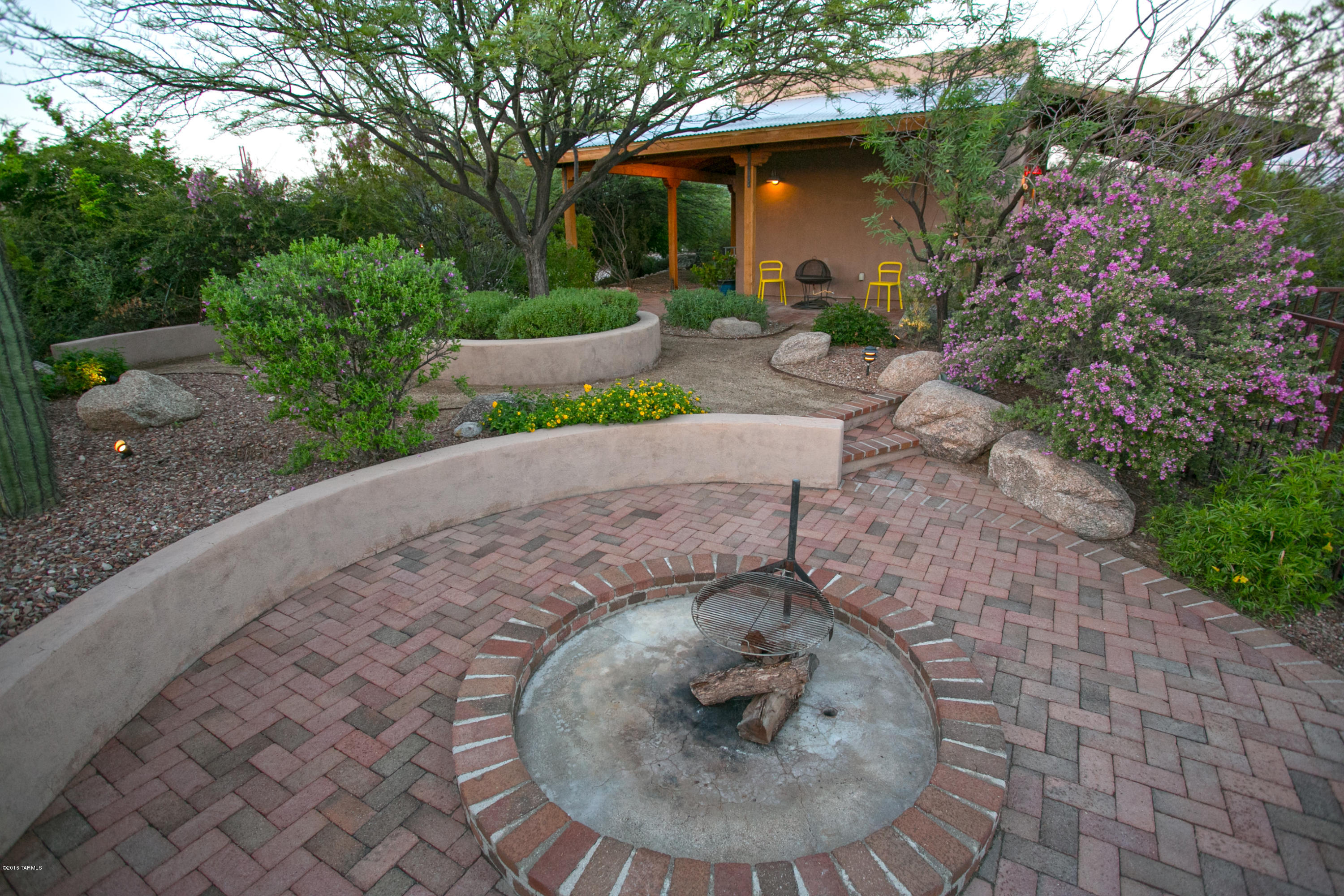 Beyond Charming & Secluded.  Immaculate 4 BR 3 Bath Custom Santa Fe w/ one 1 BR 1 Bath in Stunning Guest House! Open & Bright - Spacious Great Room Concept.  Dramatic High Ceilings, Cozy FP, & Custom Hickory Cabinets greet you as you step into this tucked away treasure. Tile throughout except bedrooms. Guest House is approx 500 sq ft & has been rented for $1200 a month  = $24,000 towards your mortgage - now that's worth stopping by. Backyard is truly a Private Desert Oasis - Prof Landscaped w/ Lush Green Lawn, Huge Bubbling Waterfall and Pond, Cool Misting System, & Wonderful Hilltop Fire Pit w/ City & Mountain Views! Tons of extras include NEW 7/2016 HVAC system, Outdoor Lighting & Sound, Work Bench in Garage, 50 AMP RV Hook Up, Custom Closets, Romantic Spa Tub in Master Bath, New paint, 2 car garage & Entertainers Dream Kitchen Island Bar.  Full sep entrance & patio and yard for quest house.  A rare find that will not last long - Call Today!