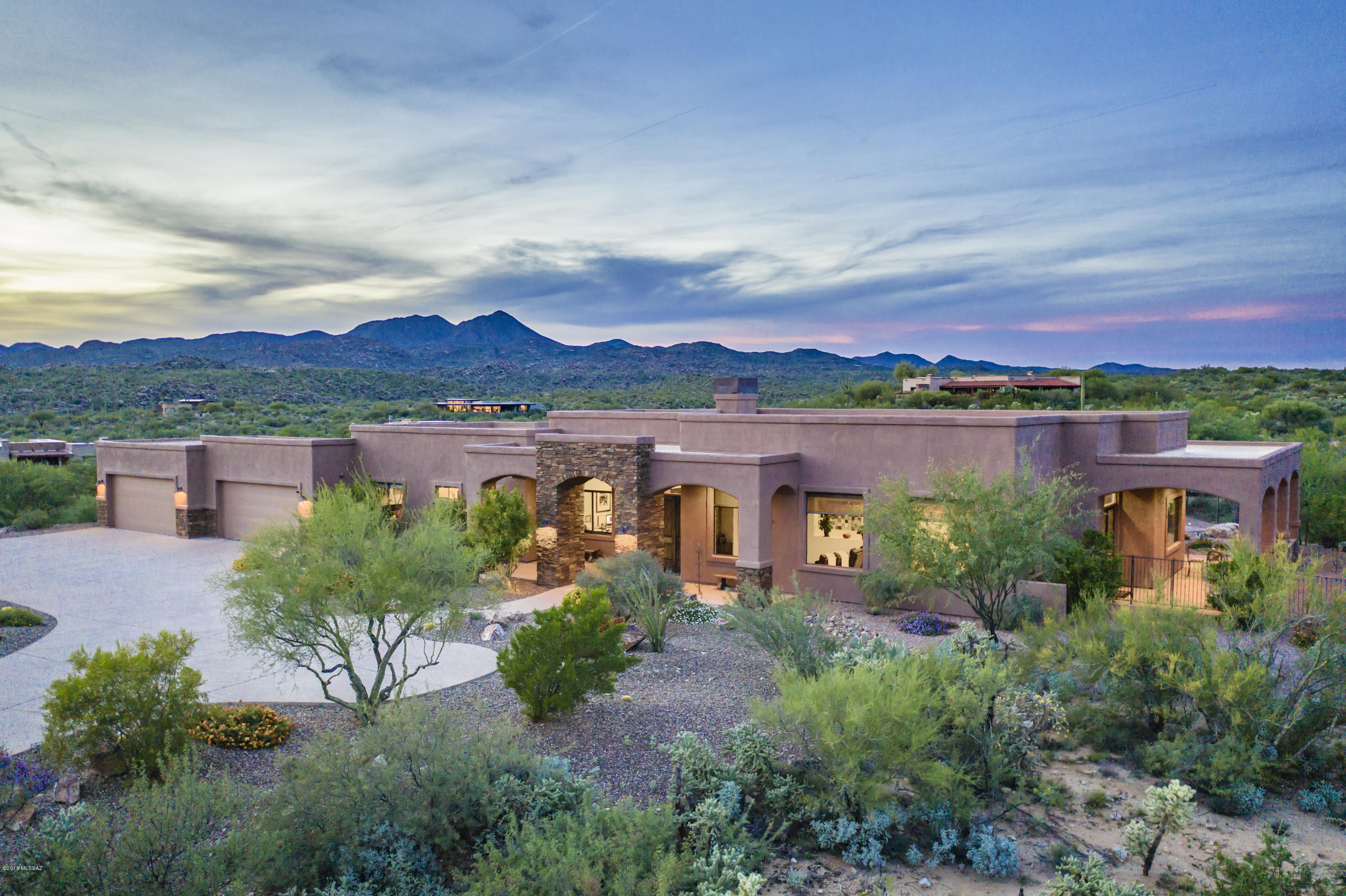 Serenity exudes at ''Tranquilla nel Deserto'' in well-built single-story 4,786sf 5BR/5½BA within the natural beauty found at guard gated Estates at Honey Bee Ridge w/Panoramic Mountain views in all directions. Casual sophistication offers both comfort & style. Extraordinary kitchen has granite counters, alder cabinets, Thermador Stainless appliances, large island w/prep sink, huge walk-in pantry & casual dining area. Spacious master suite w/luxurious bath & private patio. Stacked stone columns at grand entrance to formal parlor w/fireplace flanked by alder shelving & rustic beamed ceilings. Large great room w/dining area. Travertine Floors. Each BR has its own bath. Professional landscaped backyard w/built-in BBQ w/expansive desert views. Enormous 4 car garage.Sellers are licensed Realtor