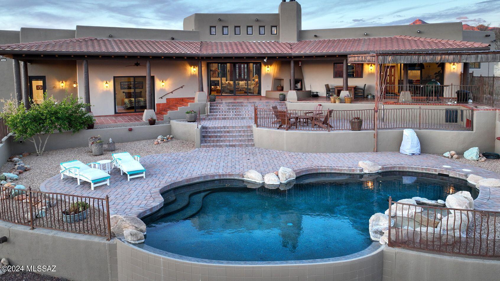 This amazing 74 acre property (up to 144 additional acres available) is located on the 20,000 acre Salero gated ranch with only 20 other homes that blend magnificently into the desert landscape.
Inside & out is a treat for the eye. 360° of mountains, flora, wildlife & during the summer monsoons, beautiful running streams. This is a contractors own home! Every aspect of infrastructure has been replaced/updated. All new HVAC, water heaters, generator, copper sinks, appliances, silicone roof, elastomeric coating outside, eggshell finish walls & ceilings inside. Exterior tile refinished & sealed.
Rustic mesquite countertops & cabinets in the kitchen. Same rustic mesquite front entry doors & matching composite Clopay garage doors. New Anderson windows. New high production solar system virtually eliminates energy bills. Truly a turnkey operation.
If privacy, peace and quiet is your desire, this ranch is the epitome. The only sounds of humanity is a rare aircraft passing high overhead. Awe inspiring vistas out of every window. Screech owls nest right outside the master bedroom. Coyotes can be heard almost any night and an occasional bobcat might saunter through the yard. 200 plus birds have been identified on the ranch. Javalina, coues deer, and jackrabbits are daily visitors year around. Unwelcome desert crawlers have virtually been eliminated by removing most shrubbery and installing 8 tons of gravel around the perimeter of the dwelling. Fig, apple, orange, grapefruit, pomegranate and key lime trees dot the property. Infinity edge pool is the focal point out from the living room however your eyes are drawn from it to the Grosvenor mountain range above that and the Black mountains of Mexico some 40 miles beyond them. The current owners lodge 2 quarter horses in a 4 stall horse barn that is complete with bathroom, tack room, tool room, and hay storage. If trail riding is your passion the ranch possesses 30 miles of road and hundreds of miles of cattle trails and arroyos to explore. There are two ghost towns and as many as 16 abandoned mines on the Salero.
State land borders the property to the north and 148,000 acres of Coronado National Forest beyond that allow wanderlust its fulfillment. This private ranch is one of the most pristine places left in Arizona and yet within 25 minutes to gourmet restaurants and culture in the quaint town of Tubac. Tucson international airport is 55 minutes to the north. Home depot, Safeway, Ross, Aeropostle, Hobby Lobby, etc. are just 35 minutes to the south in Nogales. If all of this is not enough to entice, the interior of this home is so cozy what with 4 wood burning fireplaces including one in the kitchen. Heavy timbers and 15' ceilings add way too much charm.
Your family and guests will not want to leave...

Additional acreage also available - up to 144 acres! 
BE SURE TO WATCH THE AERIAL VIDEO!
Please call Listing Agent to request the aerial video.
