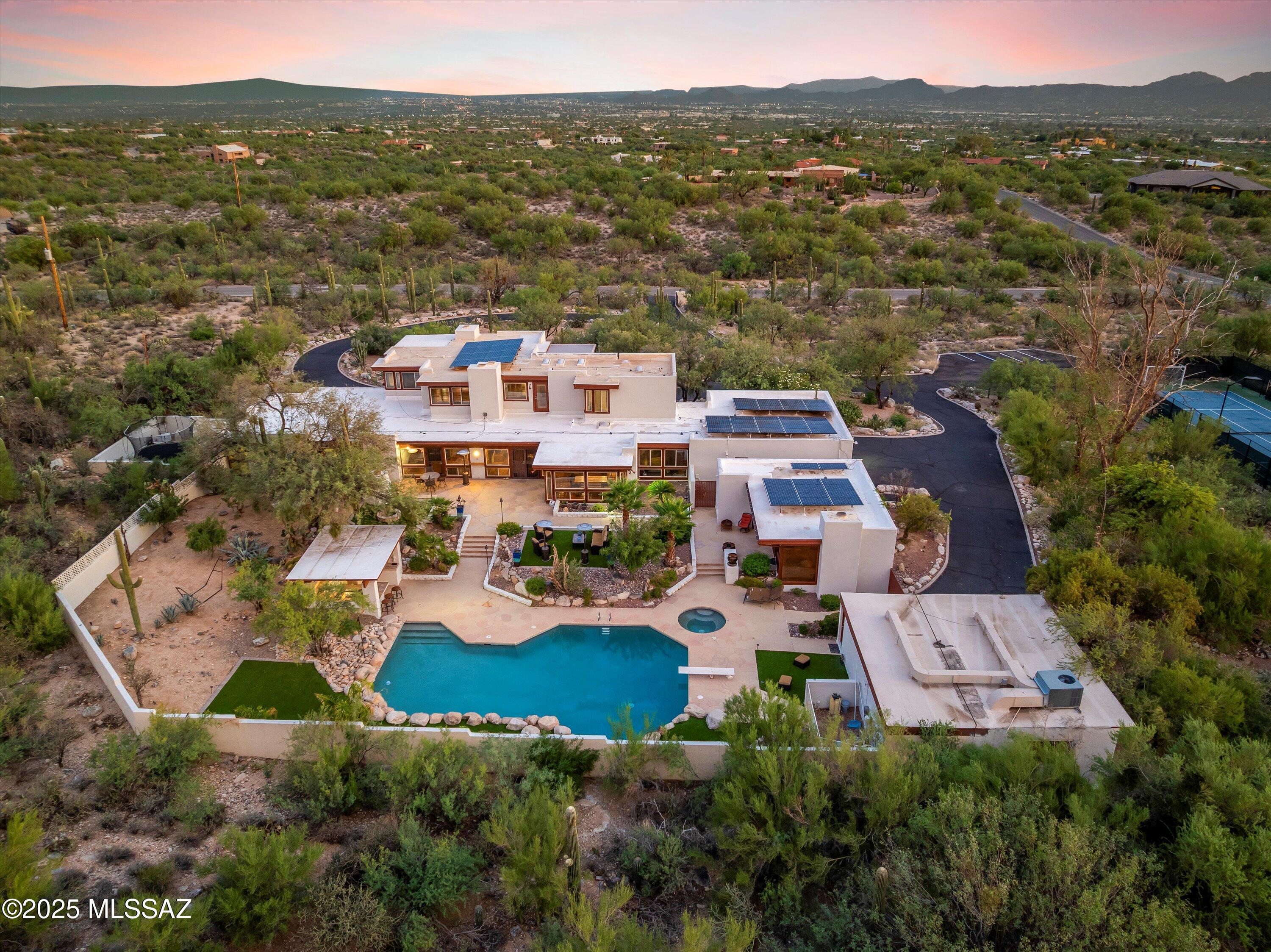 Your private desert sanctuary awaits at 801 E Calle Elena. Set on nearly 5 acres, this estate captures the essence of resort-style living with unmatched privacy, panoramic mountain and city views, and endless potential for customization. 

Behind secured gates, a sweeping and illuminated circular drive welcomes you with abundant guest parking, a 3-car garage, and room to accommodate any lifestyle. blends Spanish and mid-century influences, offering a paid off solar unit, a full-function gym, a reclining surround sound theater, and industrial-lit sport courts for all your entertaining. Come bask in the quiet beauty of the desert, in the peace of your upstairs master suite, complete with an office. THE LISTING AGENT IS RELATED TO THE SELLER. The impressive kitchen boasts SS appliances, granite counters, a plethora of cabinetry, a built-in desk, and a breakfast bar. With a private home gym and a surround sound movie theater with cinema-style recliners, you can enjoy fitness and entertainment without ever leaving the comfort of your own home. The oversized primary bedroom has a spa-like ensuite with a jetted tub, dual sinks, a separate shower, & a walk-in closet. For visiting family or friends, the private guest casita offers a cozy retreat complete with a kitchenette, bedroom, bathroom, and even a sauna. Beyond the interiors, the gorgeous backyard holds its own charm! Promising year-round fun with a covered patio, kiva-style fireplace, outdoor kitchen, built-in BBQ grill, and a sparkling pool & spa. Want MORE? This property is rich with lifestyle amenities with lighted sports courts for tennis, basketball, soccer, and sand volleyball. Bring your horses, RVs, trucks, and toys; this gem can accommodate! Grandeur, recreation, and relaxation converge in this extraordinary property! No words can describe this one-of-a-kind jewel. See it! Love it! Live it!