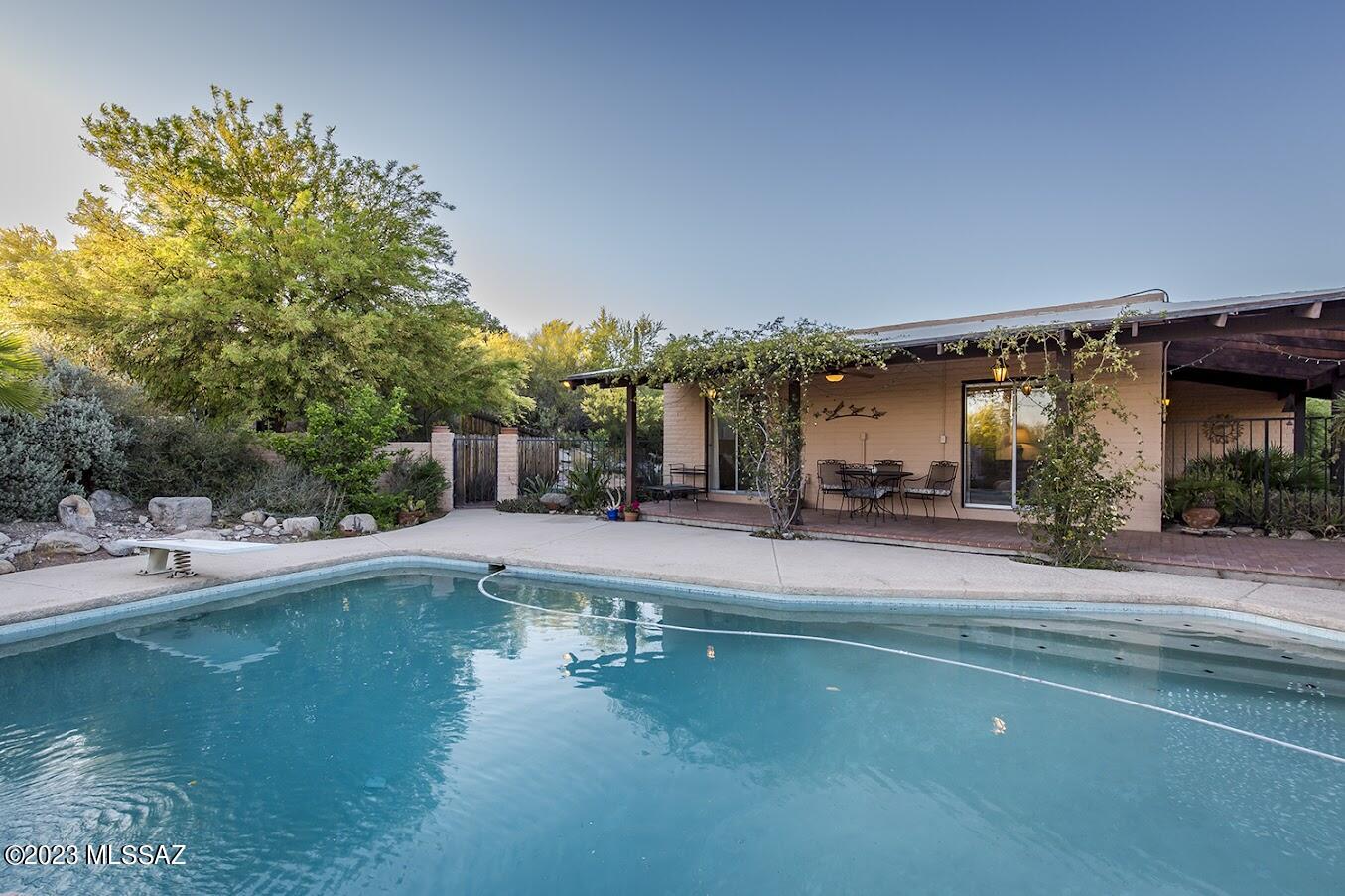Stunning and spacious four bedroom home on 3/4 acre lot in Sunrise Presidio Village.  Sparkling pool, deep and private.  This home is ready for your remodeling touches.  (Kitchen was redone in the 90's.)   HVAC is three weeks new!  Two guest bedrooms open to the deep shady patio by the pool, third bedroom is currently used as an office.  The large main bedroom and bath are completely separate, allowing for total privacy and multiple uses.  Living room still has a rock-face fireplace & wall, plush carpet.  Holiday dinners in the large formal dining room, casual meals in the breakfast area off the family room, and there's even a breakfast bar, so this is the home for entertaining or raising a big family in the foothills.