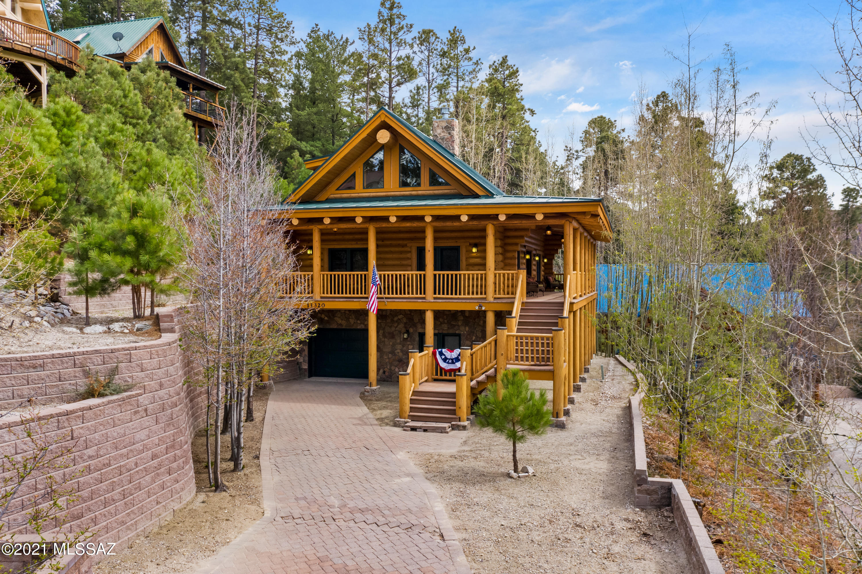 This is a One-of-a-Kind, luxurious tri-level cabin in the middle of Summerhaven. A fully furnished log cabin home designed to give you the privacy you crave, warm cozy feelings, and the mountain views you dream of. The main floor of the home has a great room, equipped with a stone fireplace that flows up to the ceiling, a magnificent kitchen with all the upgrades you could dream of, and the perfect master bedroom. The countertops in the kitchen are granite slab with unfinished edges, stainless steel high end appliances and fantastic custom lighting create the perfect entertaining space. There are also four sets of doors to access the deck so you don't miss a single second of the sunset views. Upstairs you have a grand loft, perfect for an office space or a relaxing reading nook. The upstairs bathroom has a white claw foot tub and pedestal sink. Walking past the bathroom you get bedroom number 2 with angled ceilings and amazing mountain views. Heading downstairs from the kitchen is the best part; a rec room with billiards, a jukebox, and french doors that lead to a patio. With a bedroom and full bathroom this area could truly be switched into a rental space. We have to mention that all the bathrooms have slate wainscoting, kohler faucets, and the whole house is connected to city sewer. This house has one owner who designed and built the home, it has never been a rental and it has year round access. With custom pavers in the driveway, a single car garage and a Trex built deck that wraps around 3/4 of the cabin  this house was built to last. This is a MUST-SEE on the mountain. Cabin is RANGE PRICED. Sellers will entertain offers from $995,000-1,095,000.