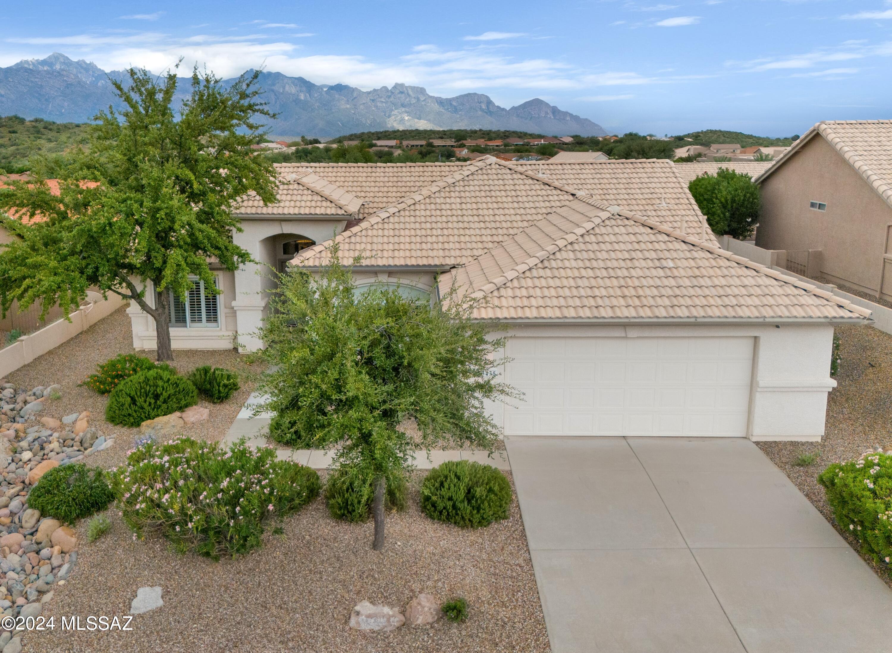 We're Proud to Present a Laredo located on a Premium Lot with Mountain Views. Great Curb Appeal! You will enter into Open Concept Living. Great Room offers Entertainment Wall that accommodates larger TV models & slider that leads to Patio. Kitchen has nice White Appliances, Island, abundance of Cabinets, Closet Pantry, & Kitchen Dining area. Owner's Suite with Bay Window. Owner's Bathroom has Walk-in Shower & Walk-in Closet. Den/Office. Guest Bedroom has Bay Window & Closet with Guest Bathroom nearby. Plantation Shutters & Blinds throughout. Laundry Room with W/D & Storage Cabinets. 2 Car Garage has 2020 Water Heater. Covered Patio with extended Paver Patio makes a great entertaining space. Lovely Landscaping, Flower Beds & Gated Yard. Just the place to call home with Mountain Views!