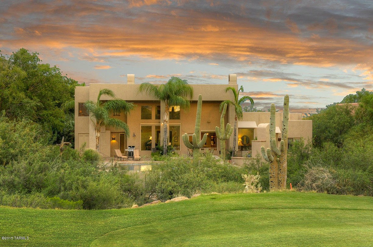 Beautiful contemporary custom home, with high 20 ft ceilings and windows with stunning vistas of Ventana Cyn golf course and the Catalina Mountains. Nicely updated kitchen, stainless appliances and granite counters open to great room. First floor master suite with den, fireplace and spa bath. Upstairs is 2 guest suites with own baths and mountain view balconies. Also on the first floor, the office, oversized laundry room, & 3 car garage. Floors are travertine and auto shades on windows. Outdoors enjoy the pool, spa, fireplace and BBQ.