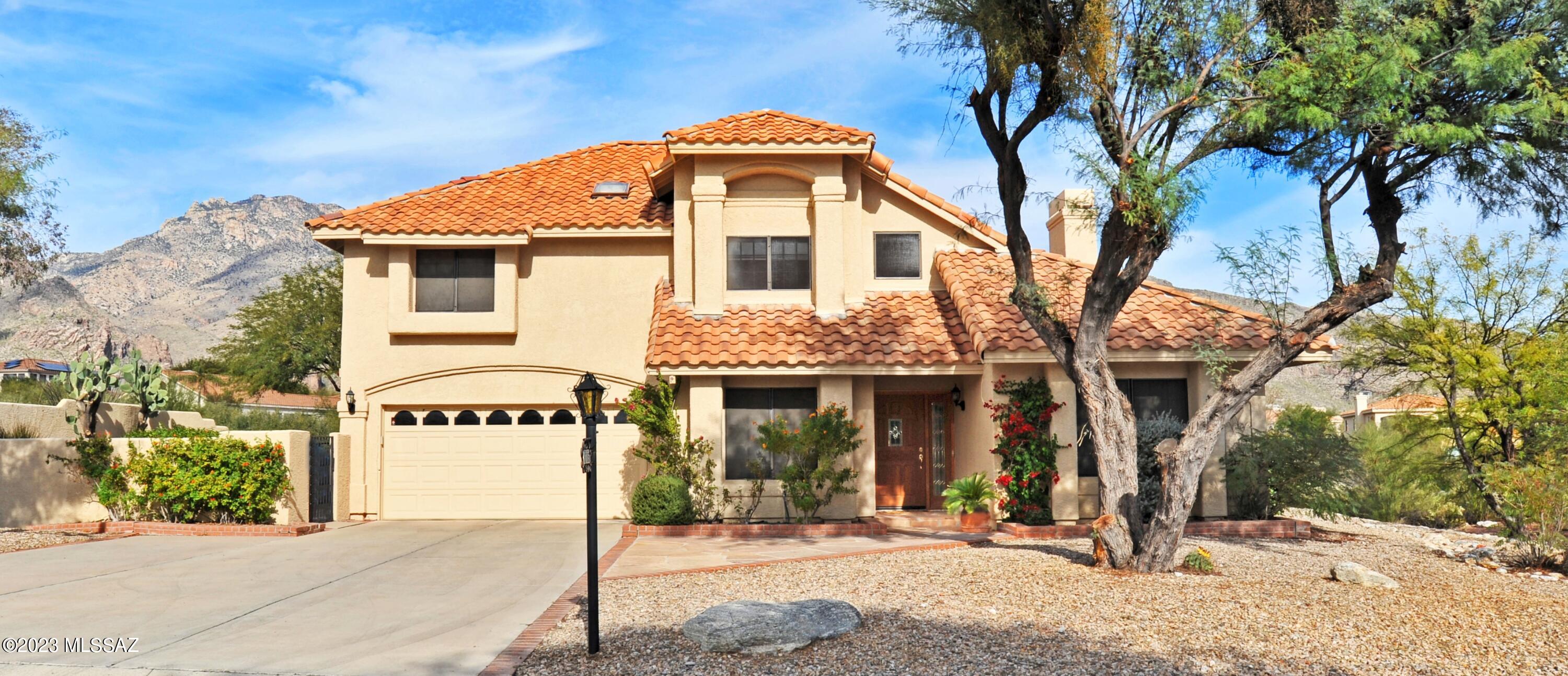 Located in the sought-after community of Casas De Ventanas, this two-story home boast breathtaking views of both the Catalina and Rincon Mountains. Situated on a premium lot with common area behind, the fabulous north facing back yard features a sparkling pool, covered patio, flagstone sitting area, turf grass, and a charming Kiva fireplace. Step inside this 4-bedroom, 3-bathroom residence offering vaulted ceilings, formal living and dining, with an entertaining family room with a wet bar and a cozy fireplace to enjoy those crisp mornings. Oversized primary bedroom features double vanity, separate shower and soaking tub w/a walk-in closet and a balcony to sit and enjoy the morning sunrise. Spacious kitchen with a breakfast nook overlooking the pool. Located in the Cat Fthills district.