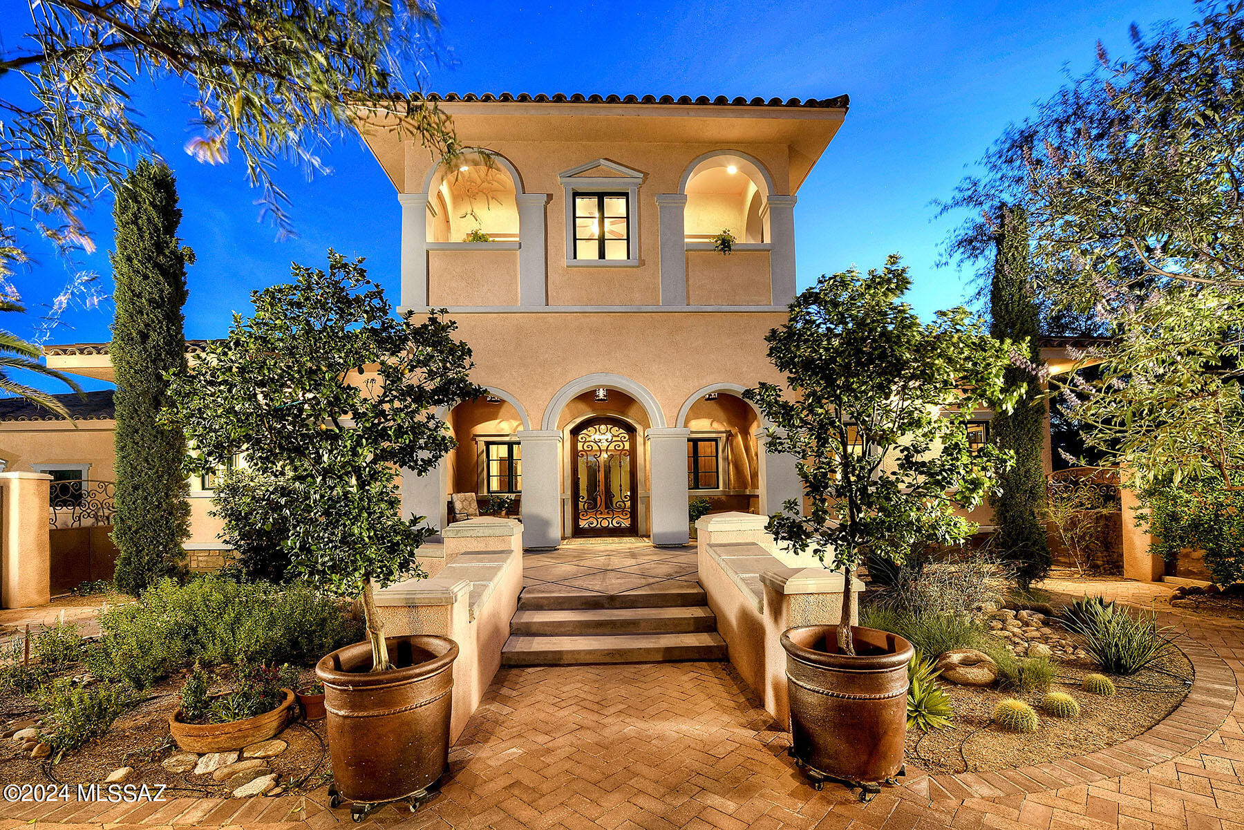 Exceptional custom home w/ authentic, upscale Italian architectural finishes inside & out. Private retreat along a natural area. Negative edge, salt-water pool w/ electronic pool cover & outdoor ramada. Features: Viking kitchen appliances & floor to ceiling custom cabinetry. REAL red oak flooring, soaring ceilings & natural light. Generous primary suite w/ designer massaging jet tub, walk-ins & fully upgraded CA Closets. Custom colored doors & window trim inside/out. Expansive gated front courtyard. Newer HVAC. No HOA. Meticulously maintained. In the heart of Tanque Verde Valley, this 3 bdrm/4 full ensuite bath has an upstairs guest suite plus a flex room (office/studio). Walk or cycle to Bear Canyon Trail Head, AZ Nat'l Golf Club, schools - great cycling & desert life