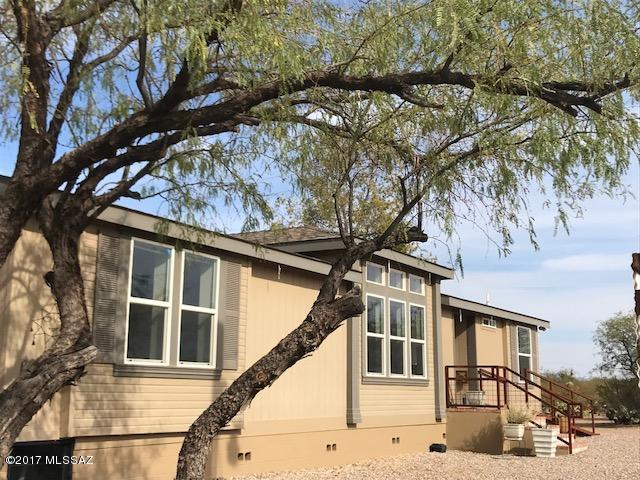 5.4 Ac of PRIVACY & SECLUSION-Adjacent Open State Land South & East - Private Automatic Gate @ Drive. An Impeccable, Lovely Designer's own home has 360'views,GreatRoom floorplan w/split BR's + Office/Den. A MUST SEE beautiful Horse Property, corrals w/shades & covered storage. Very lg open & beautiful kitchen w/GE Stainless appl. incl. refrigerator, terrific breakfast bar, pull-out shelves & pantry cabinets + 'Butler's Pantry'' laundry/mudroom w/sink & room for freezer. Many easy-access features incl. wrought iron entry ramp, Master shower, 36'' doorways, remote ceiling fans. 2.5 ac fully fenced w/barbed wire + BIG separate wrought iron fenced backyard + 8'x8' Tuff Shed ''Sundance'' w/upgraded floor & roof. WONDERFUL RETREAT just 5 minutes south of I-10,paved streets,city water+ READ MORE! This surprisingly luxurious-feeling home is in a rustic setting with beautiful unobstructed views all around...Santa Rita Mtns to the South, Rincon Mtns to North and East, Catalina Mtns to the north, Tucson Mountains to West. 
See Sunrises and Sunsets everyday.  This is perfectly "Move-In Condition". 
 Master Bedroom has a VERY LARGE WALK-IN CLOSET.  You will see the pride, care and quality of the owner when you visit this lovely property.  A terrific horse property, "ranchette" with a wonderful living space.  Seller is in the process of Pima County Minor Land Division.  2 additional lots with 2 acres each are available for sale.  Both have frontage on Andrada Road and are just west of the driveway in to this property.  Listings will be available soon.  There is a locked back gate on the south of property fence line into 355 acres of Open State Land adjacent on the east and south for riding or hiking.  See the attached plat map in "Documents" tab for site of house, gate, fences, and the 2 acre lots to the north of this Parcel 1 on the plat.
Builder's Upgraded Packages: "Energy Star" Package (upgraded insulation, windows, water heater, HVAC heat pump w/ overhead ducting)  "Saguaro Package"(upgraded doors, trim/basboard, drywall round corners throughout, recessed can lighting, 3 remote ceiling fans, skylight "Solatube" & cabinet upgrades.  Premium Appliance Package: stainless steel.
Upgraded architectural fiberglass shingle roof.
2" x 6" exterior wall construction
R 19 Wall Insulation
R 42 Roof insulation
R 22 Floor insulation
40 gallon electric water heater
13 seer heat pump
Custom milled wood interior window sills