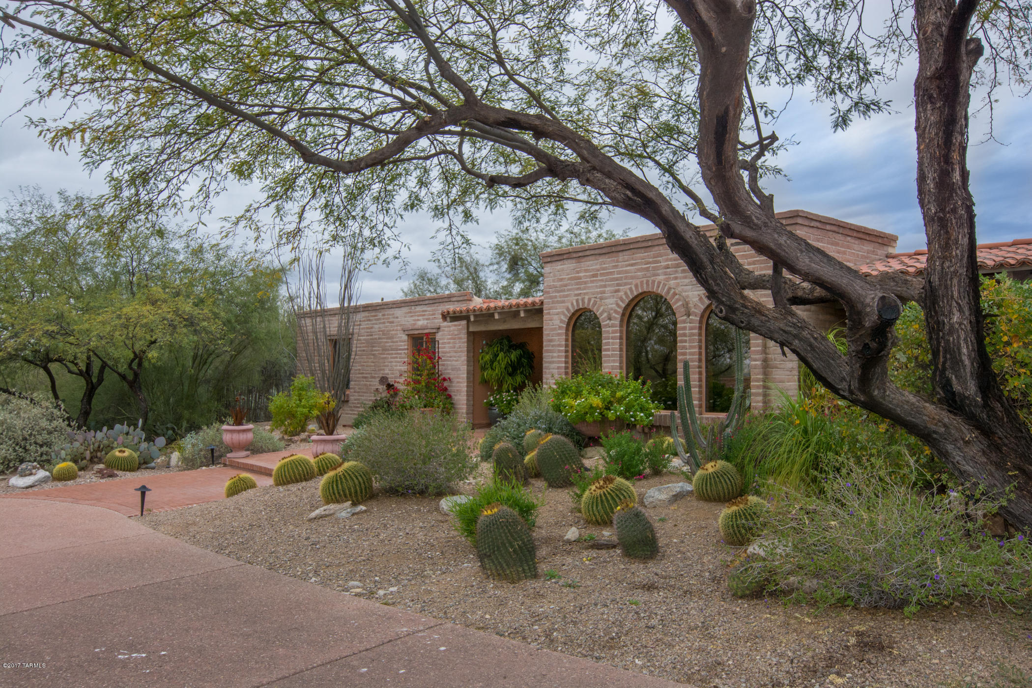Charming Burnt Adobe Residence quietly tucked away in Catalina Foothills #9. Solid construction, Premium location. Stunning unobstructed Catalina Mountain Views! Beautiful desert landscaping surrounding the home and patios, provides unusual privacy and seasonal desert color. A quality Tucson residence updated with detailed perfection; Red oak wood floors, solid wood doors-throughout! Updated kitchen and baths, dual pane windows. A design, rarely found, compliments our unique Arizona lifestyle. Most rooms open to outdoor covered ''living patios!'' An EZ flow to advantage outdoor living areas for entertaining or personal enjoyment. Terraced back yard patio areas surround the pool w/built in fire pit! The best of ''Arizona Foothill Living; best of Tucson restaurants. Full service shopping at La Encantada! Vistas of the Catalina Mtn Range and the Sonoran Desert-your backyard!