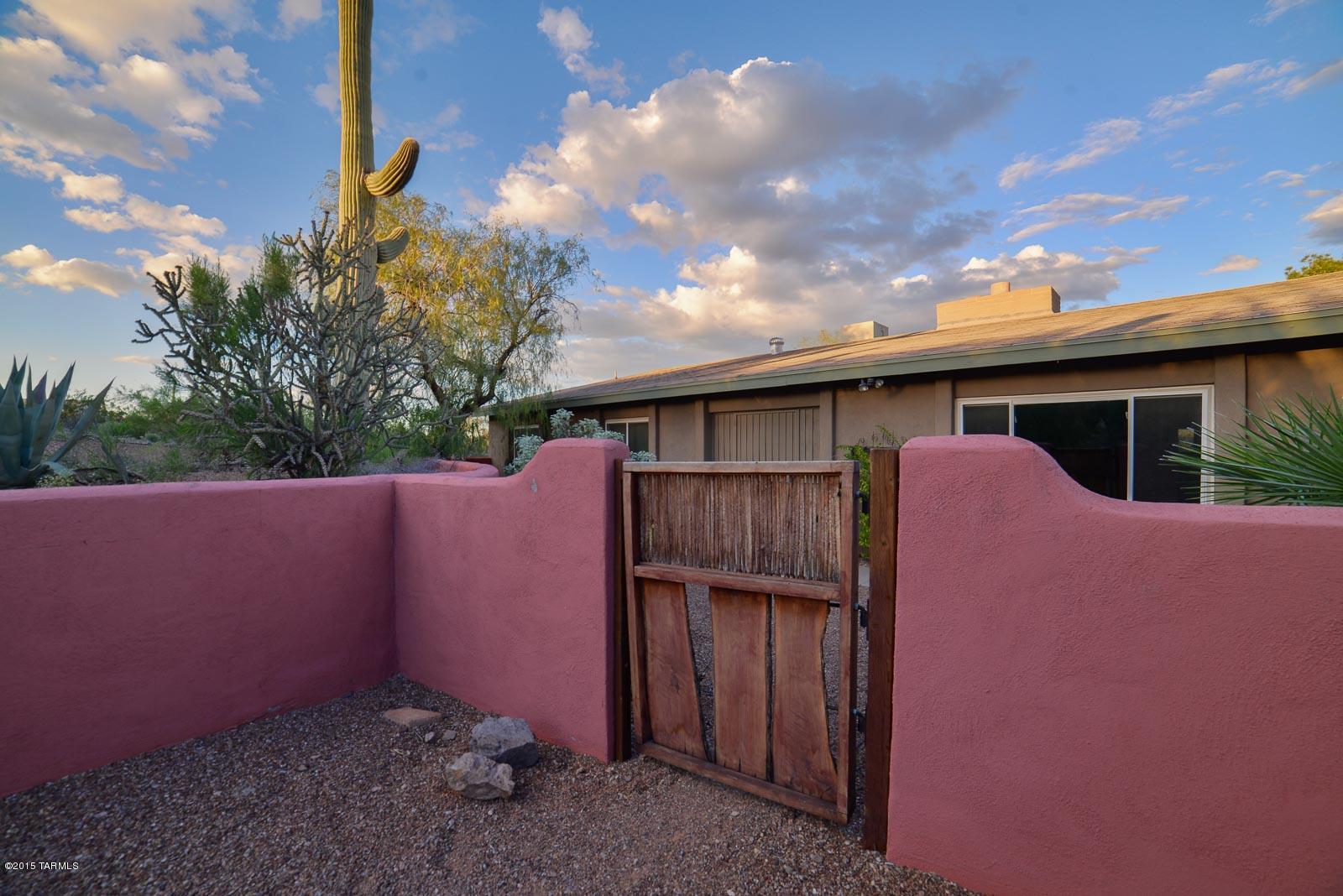 This prime west side location offers a home with upgrades and features in ready to move in condition.  The large one acre property offers spectacular city and mountain views from the new  pebbletec solar heated salt water pool.  The pool comes with fast lane by endless pools.   Surrounded by lush sonoran desert, landscaping is natural and low maintenance. Enjoy city lights from the screened in AZ room, side patio, or the pool area. The kitchen and baths have been remodeled and the home has triple pane UV coated windows for low utilities.  Main living areas have tall wood beamed ceilings, double sided fireplace, freshly painted interior and new carpet in bedrooms. Kitchen has granite counter tops, tons of beautiful cherry cabinetry. Lg garage may fit up to 6 cars tandem, buyer to verify.