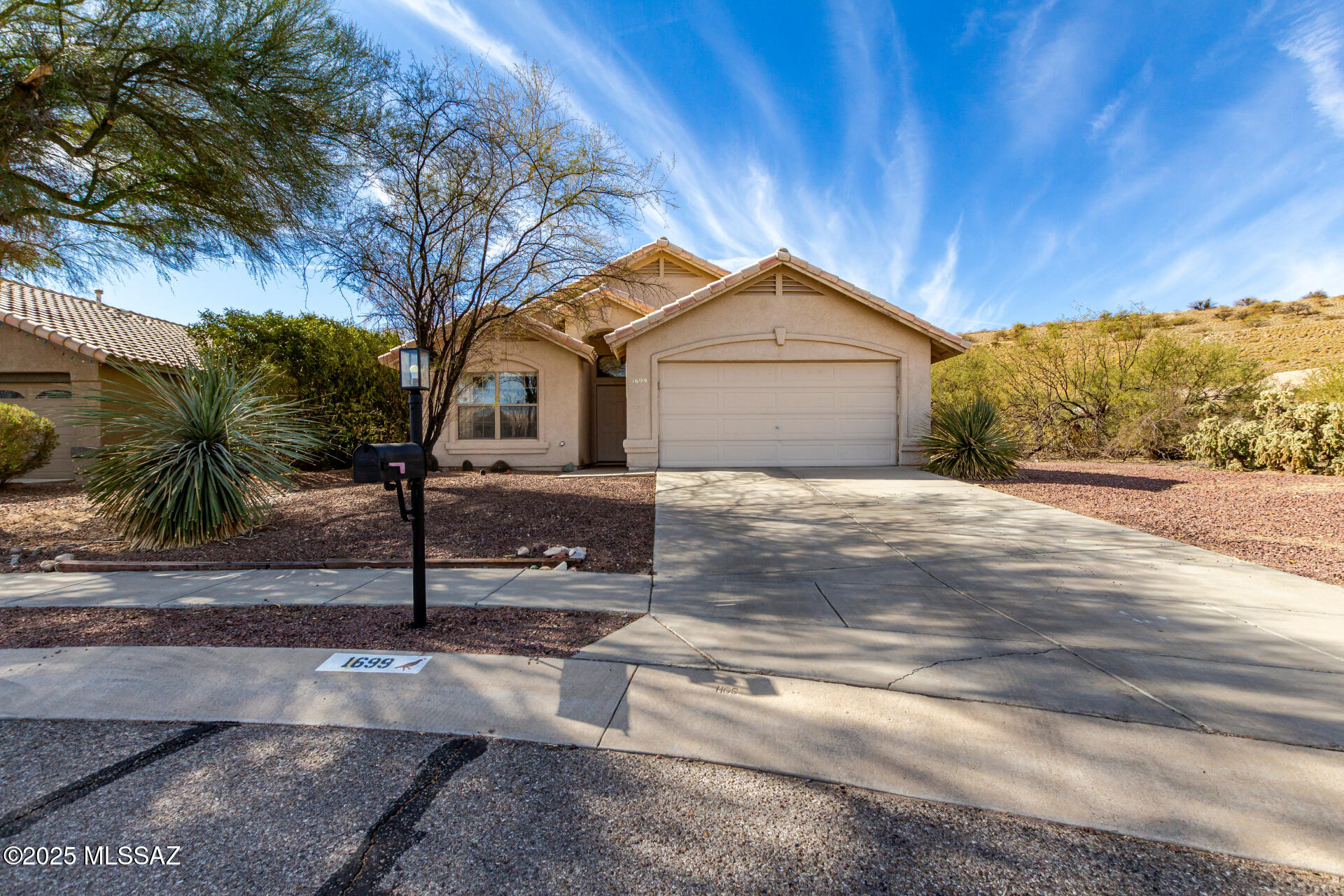 Fall in love with this delightful 3-bedroom, 2-bath residence on a peaceful cul-de-sac! Discover a bright interior showcasing a living room with soaring vaulted ceilings, a soothing palette, and durable tile flooring for easy maintenance. The gourmet kitchen comes with warm wood cabinetry, contemporary track lighting, built-in appliances, a pantry, a center island for extra prep space, and a two-tier peninsula with a breakfast bar. The main bedroom offers a practical walk-in closet and an ensuite with double sinks. Enjoy quiet evenings in the sizeable backyard, complete with a covered patio, stunning mountain views, and abundant space for crafting your dream outdoor oasis. Make this gem yours before it's gone! Temporary 1-0 buydown offered by preferred lender for qualified buyers.