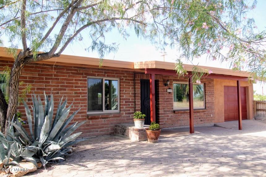 Listed below recent appraisal! Midcentury boho treasure in midtown! Spacious with exposed beams, clay tile flooring, a lovely dining area/ sunroom, office, and a truly huge  family room addition. (office, photo 7, used to be a 3rd bdrm...easy enough to convert back!) The bath is just one, but has been remodeled: a spa bath with jetted tub, glass block shower, skylight. All of this plus your own private outdoor oasis! Older pool is lovingly maintained, shady ramada, outdoor kitchen, two yards, all with 6 ft block privacy walls.   Front driveway has custom rusted metal fence for privacy from Craycroft.  Don't miss your 2nd  chance at this wonderful property!