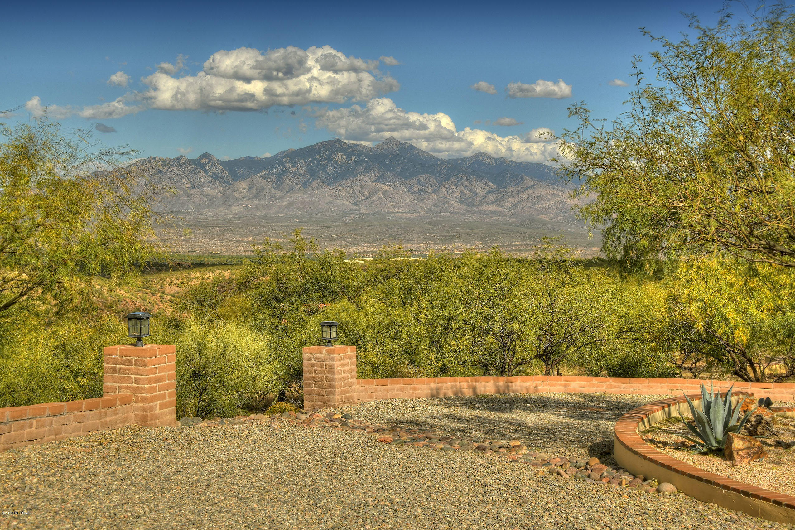 Gorgeous custom home on 7+ acres nestled among  the majestic Tumacacori Mountain foothills.  Ideally situated for panoramic views, the homes gated drive, magnificent finishes & landscaping softly blend this 3755 square ft home into it's surrounding mountain setting. Iron entry gates welcome you to the main hacienda style courtyard w/fireplace, fountain and separate Casita entry.  Enter great room & light fills the main living areas (great room w/large fireplace, mesquite mantle/bookshelves, open truss beams, gourmet kitchen & dining room).  Fabulous Master and guest suites. New Trane 2-stage heating/cooling systems. Stunning pool (with sunken stools) & spa just steps from Master BR. Multiple covered patios w/outdoor cooking.  Simple synthetic grass & rock landscaping.  Large 3 car garage.