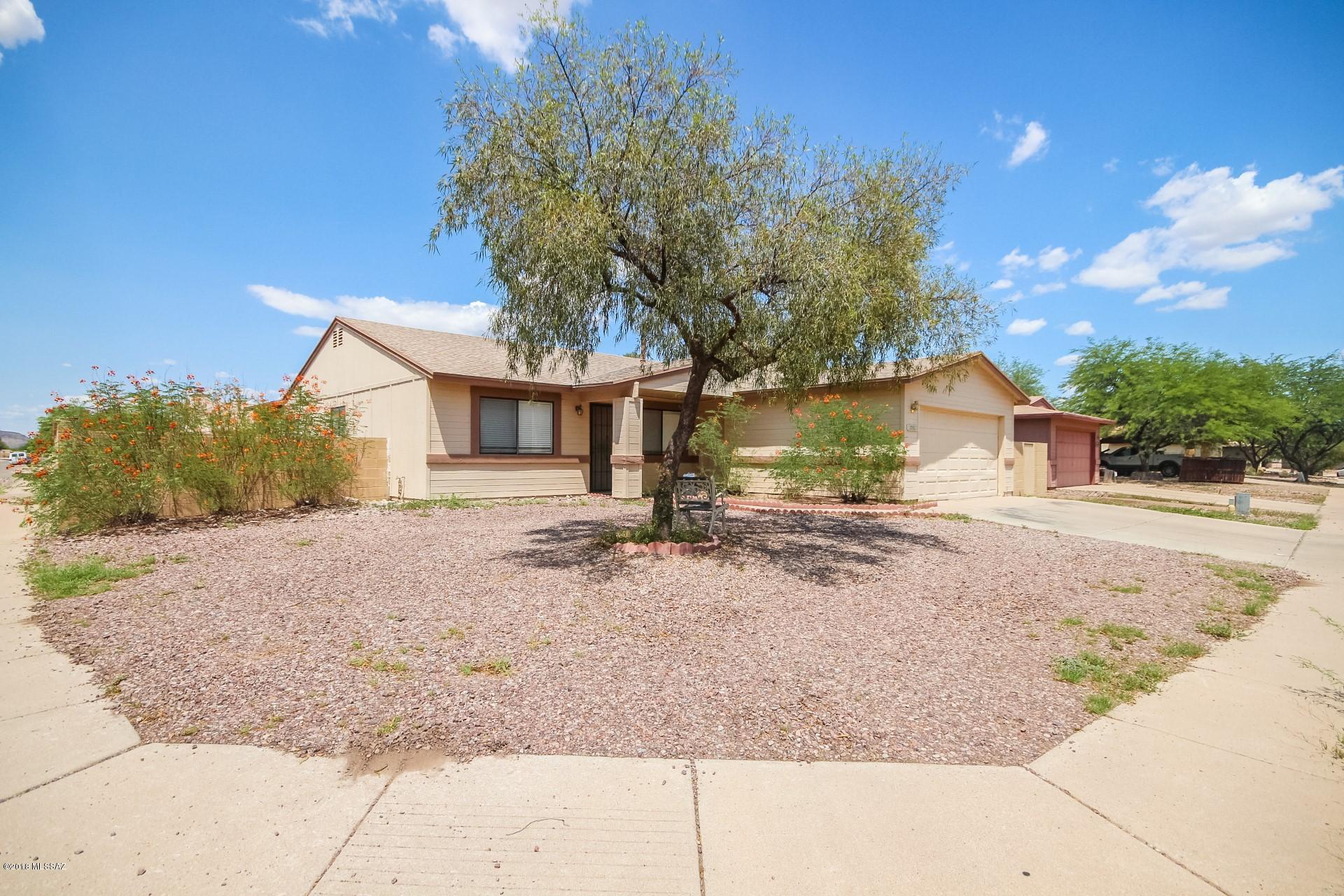 Home sweet home! Fantastic Tucson home with easy access to I-10, I-19, and the University of Arizona! Fall in love with the flowing floor plan that features a formal living room, family room, and three spacious bedrooms! Neutral color palette throughout including tile flooring. Eat in kitchen opens to the family room and boasts a plethora of cabinets, ample counter space, and a raised breakfast bar. Master bedroom has an en suite with private toilet room. Relax under the covered patio and enjoy the serene surroundings, and the abundant sunshine! This home will not be on the market long! Make it your first and last stop!