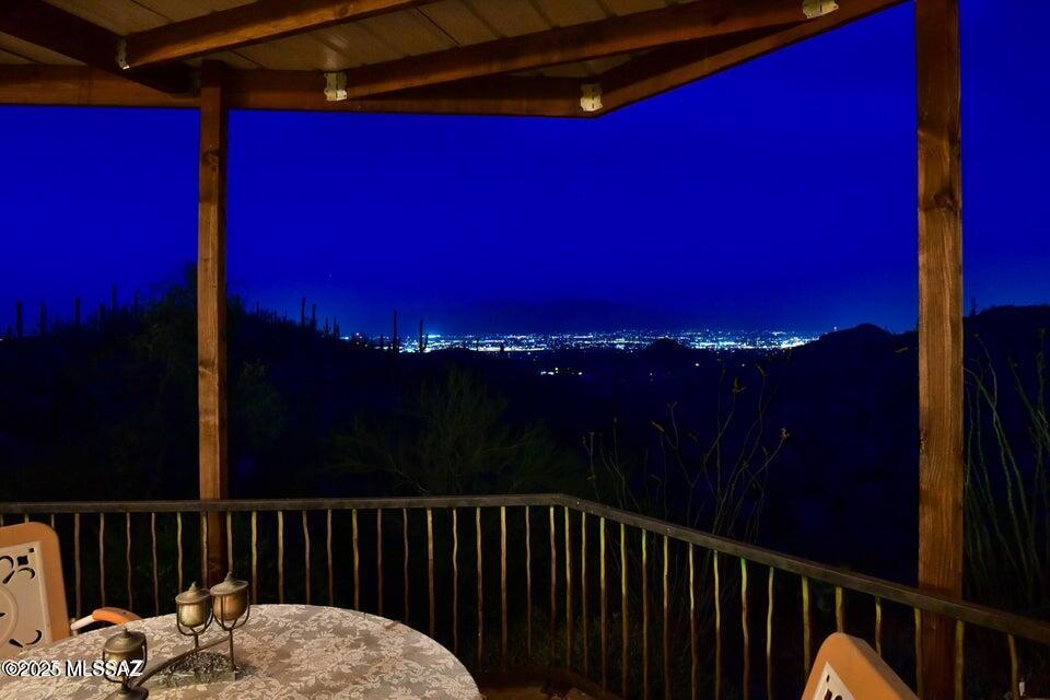 This spectacular custom built home situated high in the Tucson Mountains is not just a home, it is a lifestyle! This 3.53-acre property offers awesome views from city to mountain, a serene connection to nature, and an environmentally friendly platform. From the moment you enter, you will appreciate the warmth, the elegant beauty and the subtle artistic touches throughout. This home is thoughtfully designed for multi-generational use with guest wing as a fully self-contained living space. Also on the property is a greenhouse where you can grow your own food. As well, there is a separate round house, Casa Della Luce which can be used as an art gallery, a meditation room or a beautiful gathering space. Don't miss this wonderful home you will not be disappointed and located 10 mins to freeway