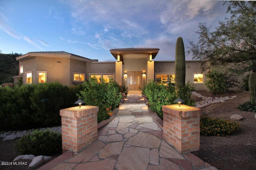 This property is spectacular! Located in a small, gated community, you have lots of privacy! Grand front entry with flagstone bridge. Enter main level that features living room, formal dining, 3 bedrooms (all with a bathroom), & large kitchen open to the family room.   Kitchen is bright & open featuring SS Appliances, granite counters & walk-in pantry.  Just a few stairs to upper level that features mini loft, office & fabulous master suite with fireplace & sitting area. Lavish master bath with dual shower, spa tub, microwave & mini fridge. Laundry room & garage access in lower level.  X-large 3 car garage. Lush multi-level backyard with covered flagstone patio, pebble tec pool, fireplace & fruit trees.