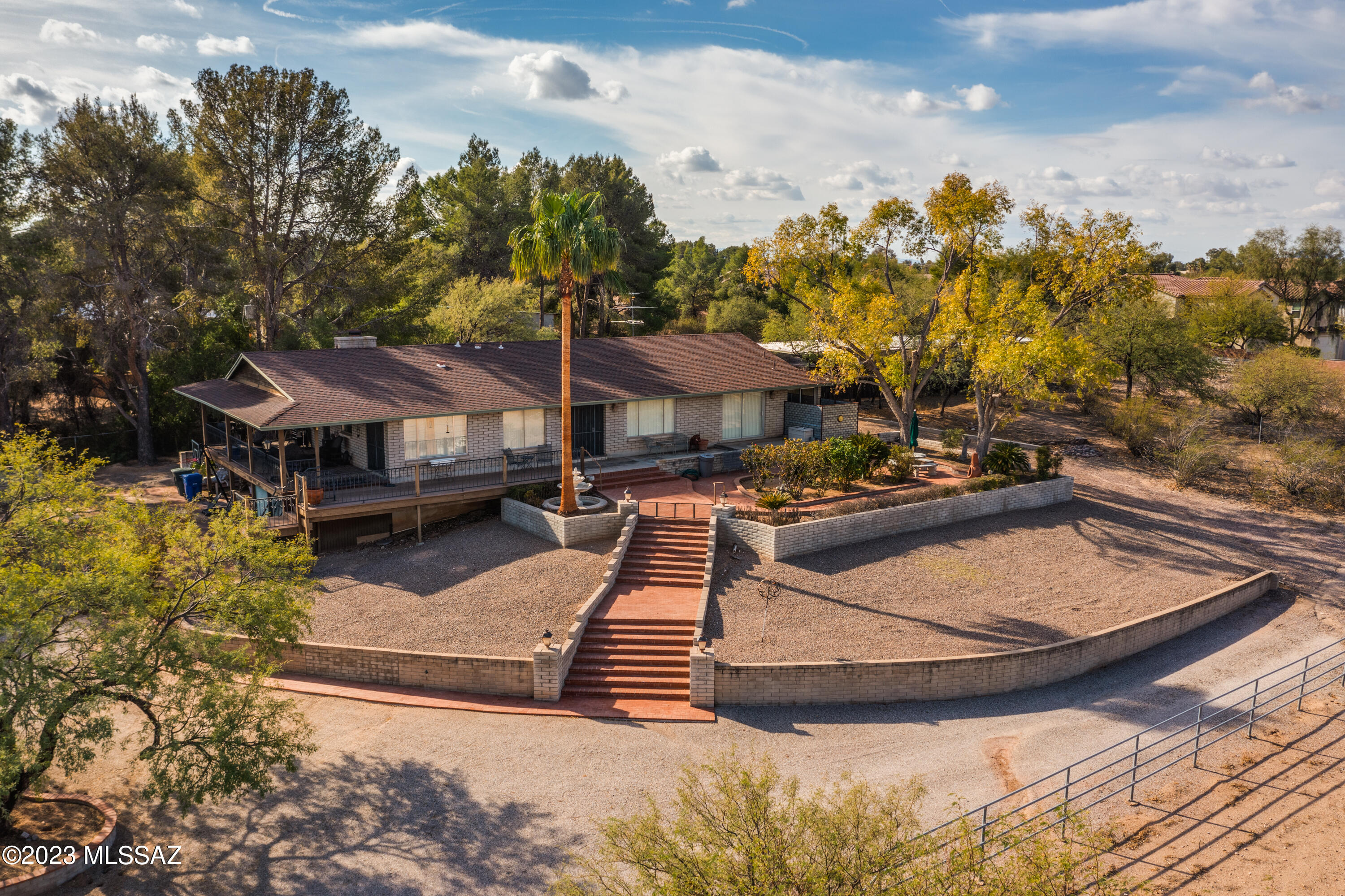 Situated on over four acres just outside of the Old Ft. Lowell District, this property is ideal for equestrian enthusiasts or those seeking a touch of country charm within city limits. A primary residence, 6 stall barn with tack room & wash rack, large riding arena, turnouts, two car carport, and additional covered parking complete this sprawling estate. Plenty of space for entertaining, & enjoying Tucson's beautiful sunrises and sunsets, & breathtaking mountain views from the deck. The home features sizable bedrooms, 2 full bathrooms, spacious family room, & a formal dining room. For nearly 40 years, this home has been cherished & lovingly cared for. Minutes to TMC, shopping, entertainment, & easy access to The Loop for trail riding & biking. Such a rare and fantastic opportunity!