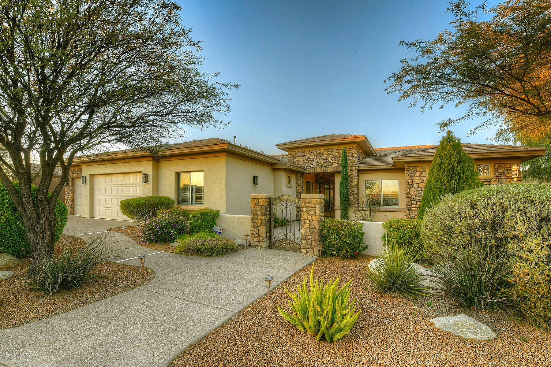 Gorgeous custom well maintained home w/in the gated community, Vistoso Highlands, of Rancho Vistoso. Enter through your private brick courtyard into the beautifully appointed interiors. Great room design offers open living/dining space w/ floor to ceiling windows & a cozy stone fireplace. Split floor plan featuring 4056 sq. ft, 4 bedrooms plus office, & 3.5 baths. Extensive & detailed rock work throughout the home adds to the unique & custom feel of the home. 3 fireplaces (great room, living room, & master suite) make you feel right at home. Premium kitchen appliances w/ a gourmet Miele Built-in Coffee maker. 3 car garage. Enjoy stunning mountain views from your resort style backyard. Includes built in kitchen, & extensive covered patio. Luxurious Pool/Spa are all awaiting you!