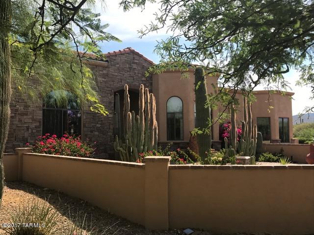 Attention paid to detail in this custom 100% solar supplied home on over 3 acres of pristine desert with incredible mountain views. Open floor plan concept and natural light 5 BR & 5 baths, updated kitchen, split floor plan, separate guest room with independently HVAC. Guest quarters with bath, tankless instant on hot water heater, 4 car garage. Quality hardwood flooring, Spacious and light with large picture windows and many skylights, large master suite with remote control window coverings and beautiful master bath. Custom window coverings and energy efficient LED lighting, wrap around rear and side patio with tile floors, outdoor kitchen, luxury pool with slide and outdoor shower, landscaped grounds and fenced backyard.